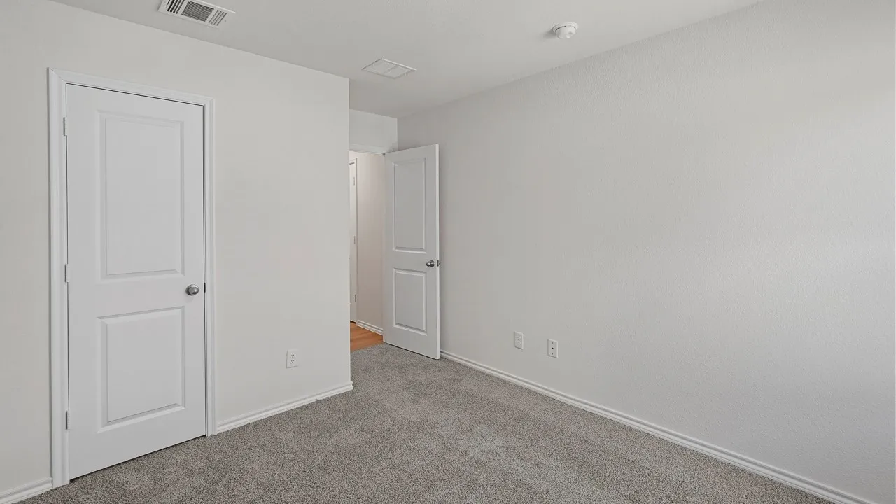 Neutral wall tones with gray carpet flooring and white trim