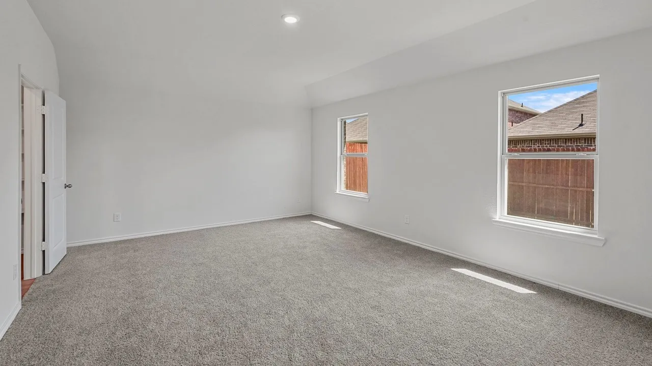 Recessed ceiling lighting, vaulted ceiling, and two windows