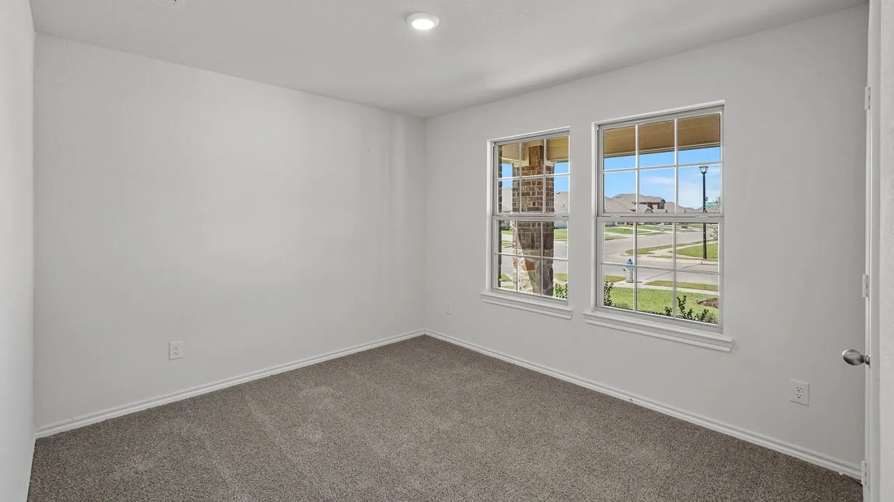 Neutral wall paint, plush carpet flooring, recessed ceiling lighting, and two multi-pane windows