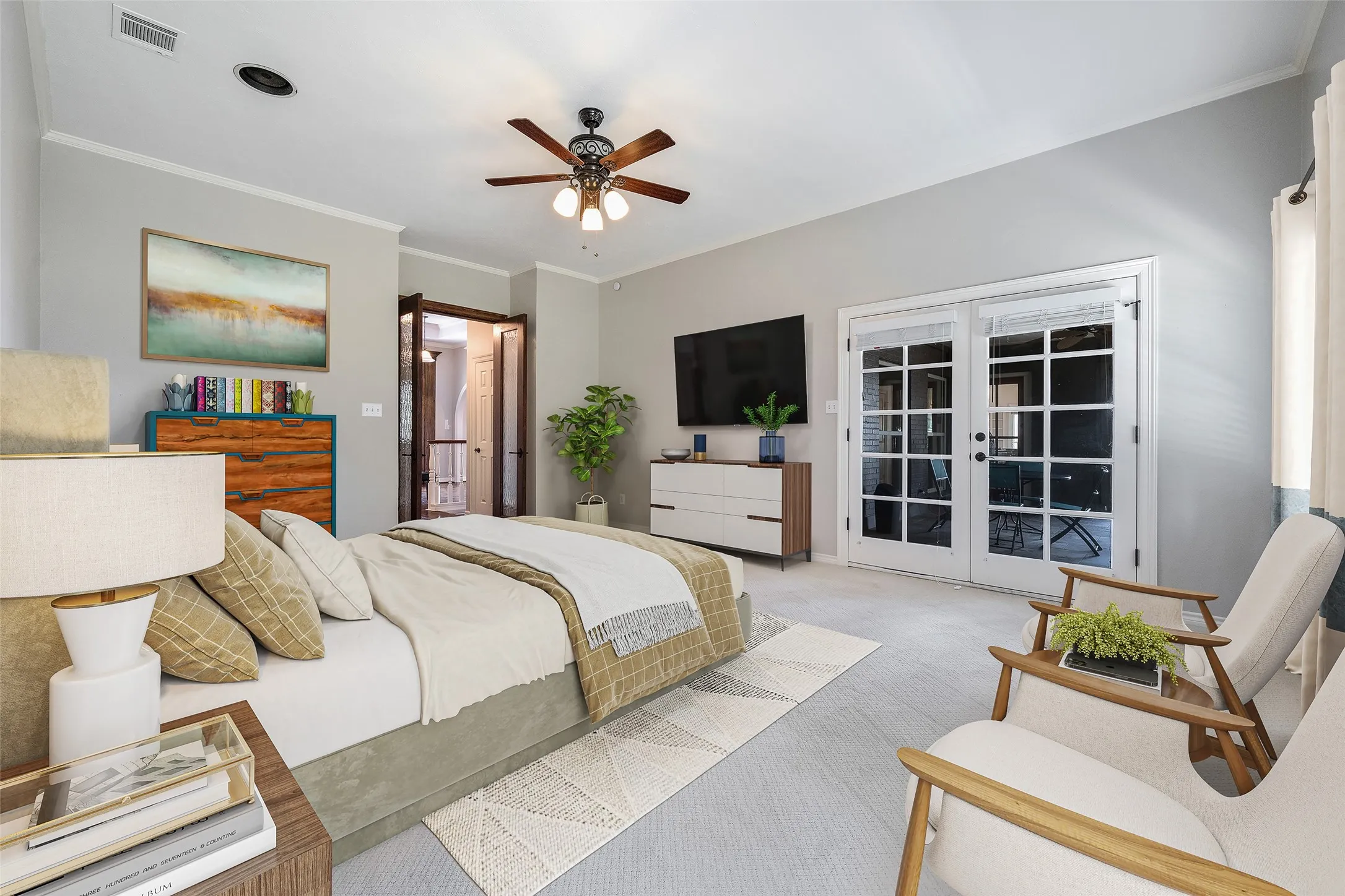 Virtually staged. Large primary bedroom with french doors leading to screened in porch