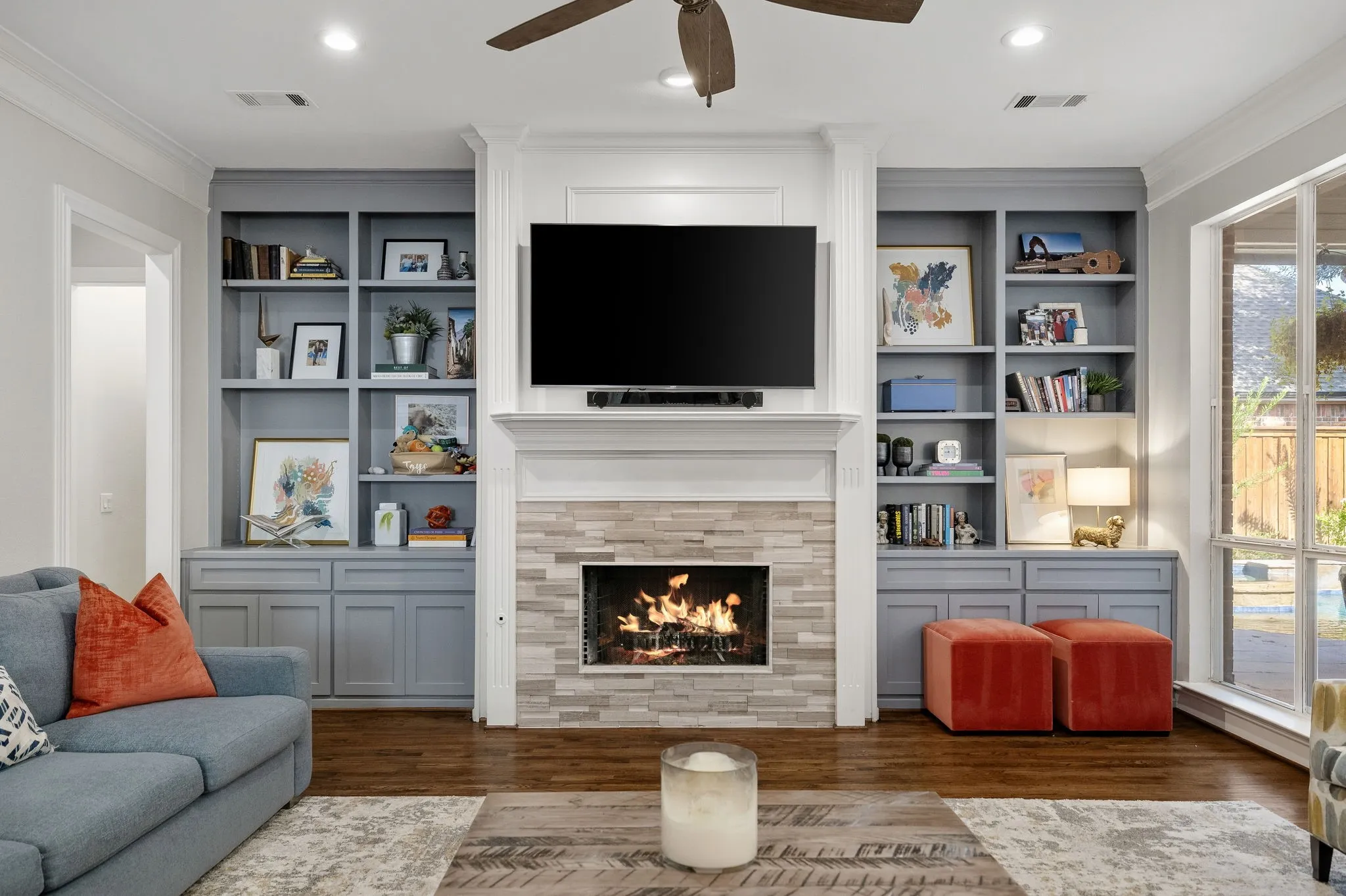 This gorgeous remodeled fireplace is flanked by custom cabinetry.