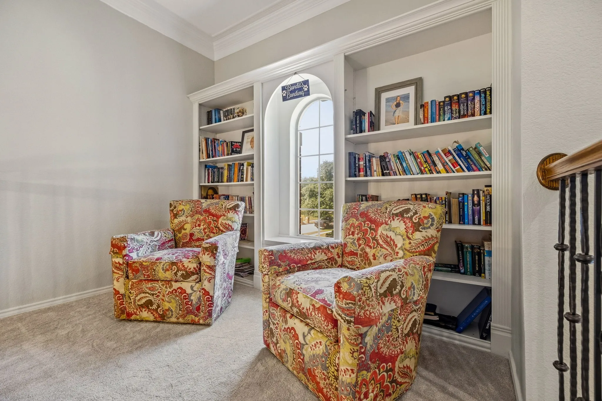 Upstairs library has built-in bookshelves & overlooks the entry.