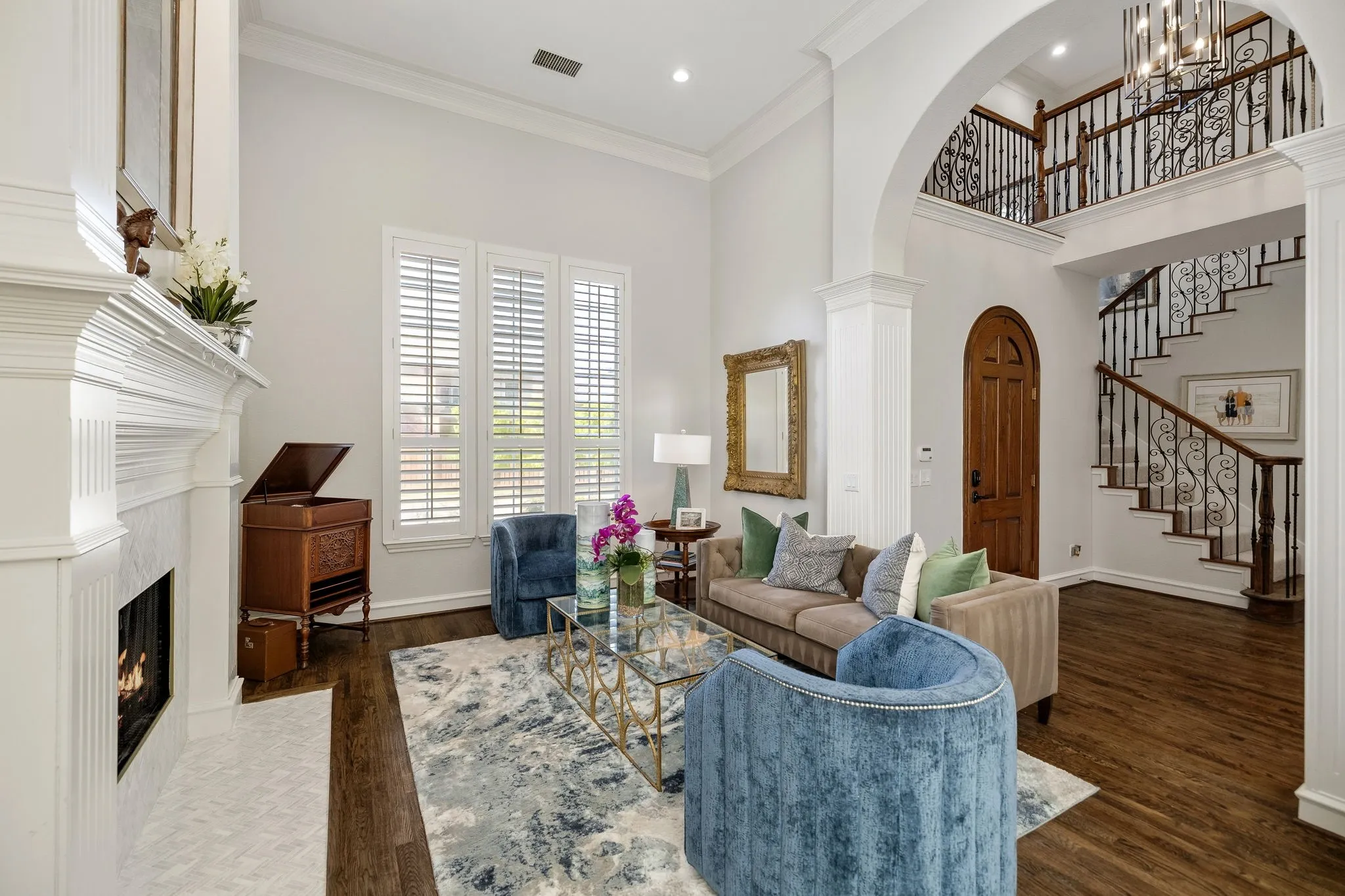 Beautiful entry with first staircase and open to formal living room.