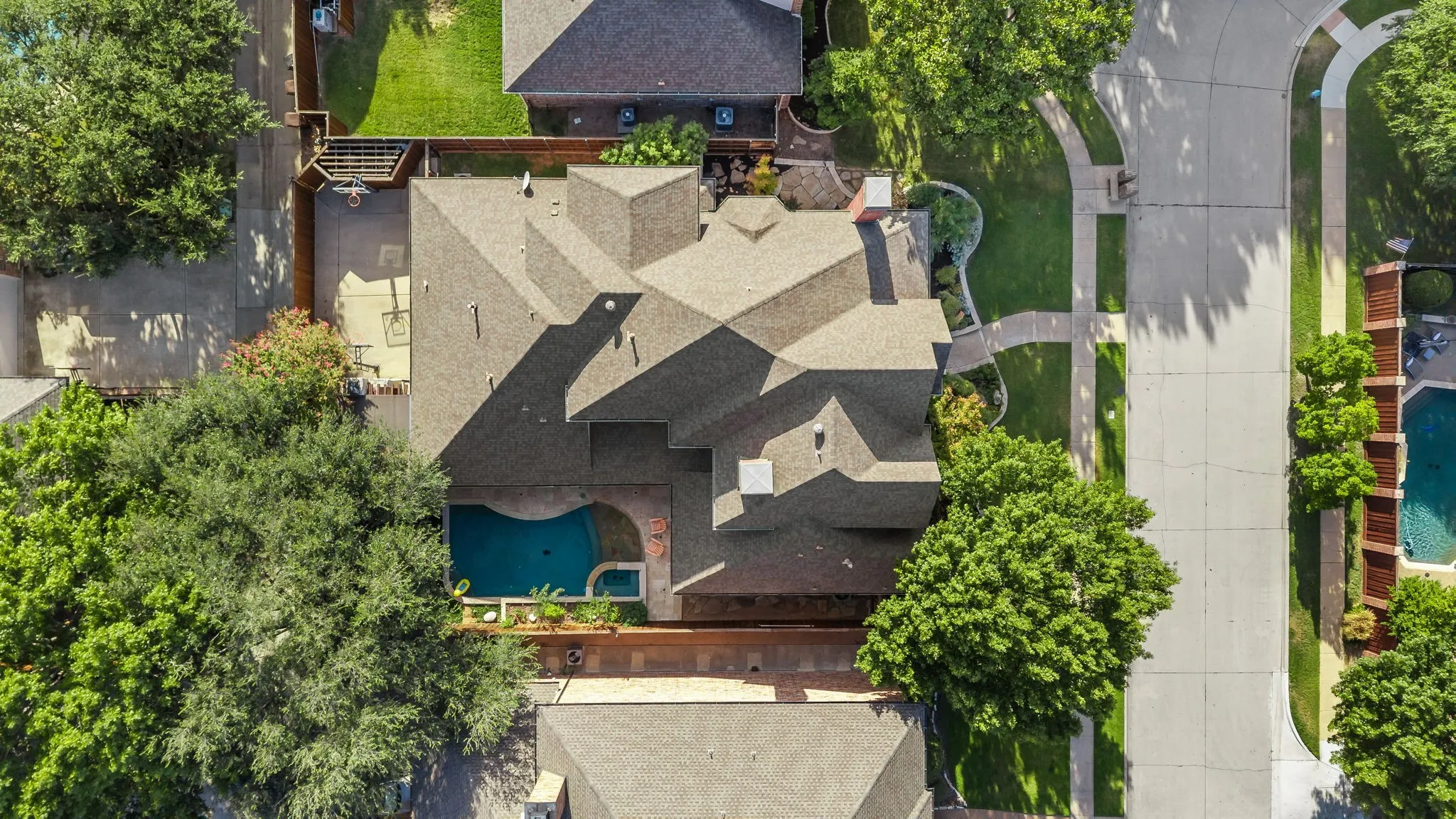 Sliding gate enclosing 3 car garage, 2 basketball goals, storage shed, dog run with laundry room access.