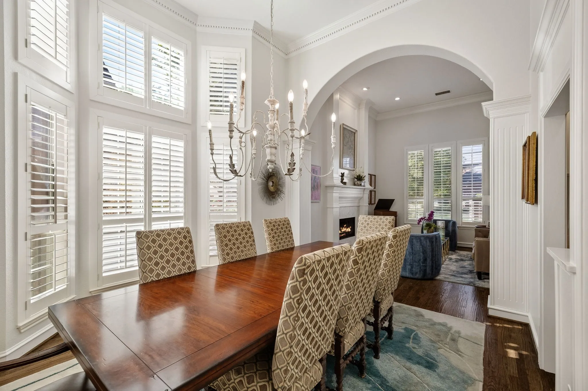 Designer chandelier, plantation shutters, access to the kitchen & wet bar.