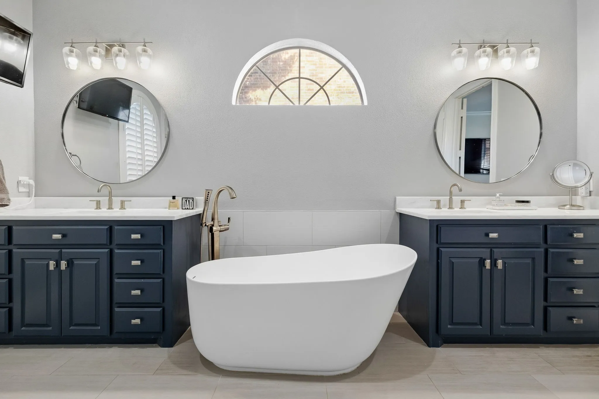 Magnificent bathroom remodel with free-standing tub & custom cabinetry with dual vanities.