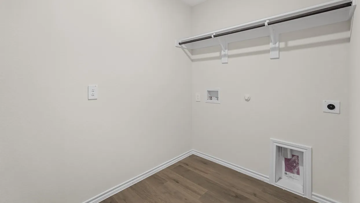 Laundry area featuring wood-finish flooring and a built-in hanging rack