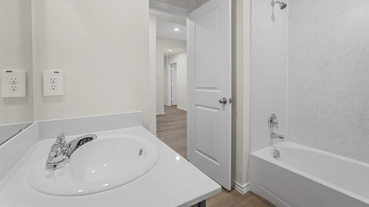Bathroom vanity with an integrated sink and chrome faucet