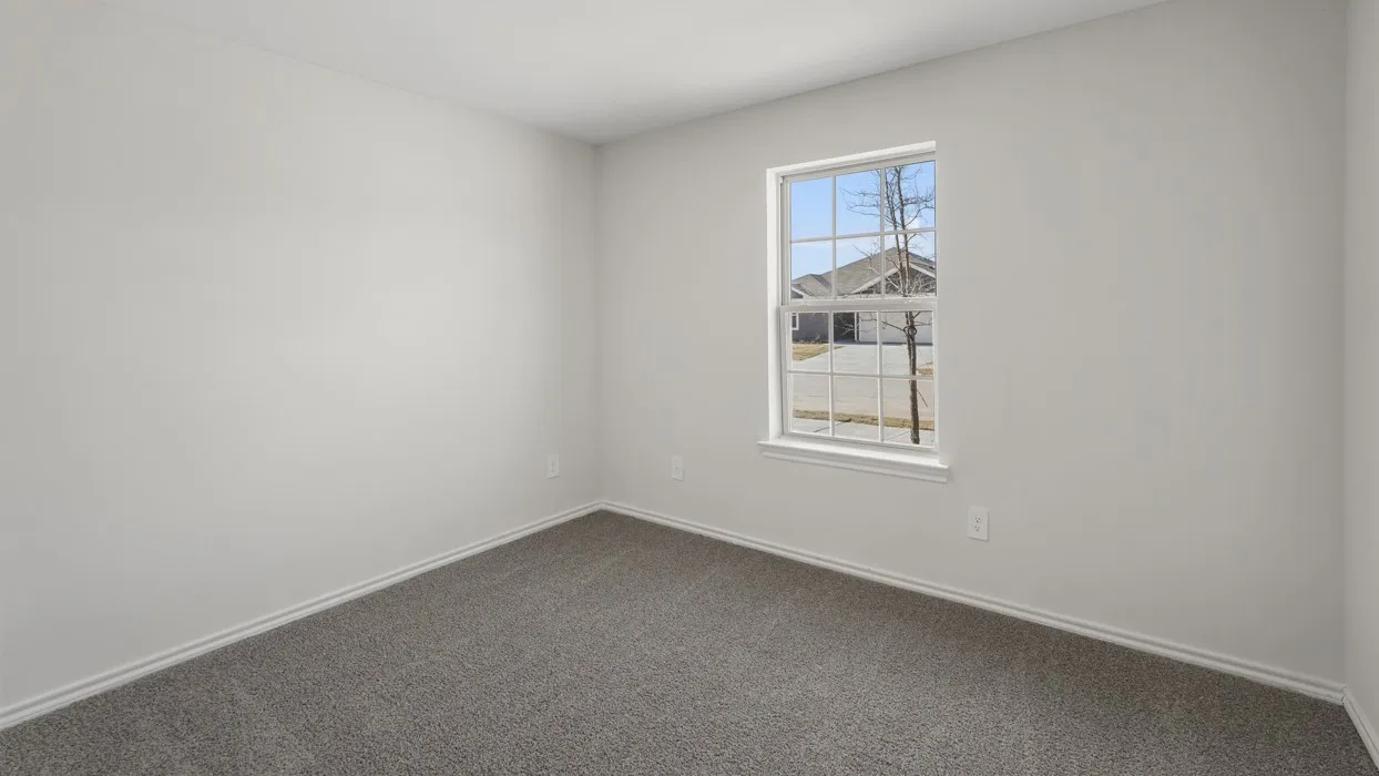 Windowed interior space featuring light gray walls, white trim, and gray carpeting