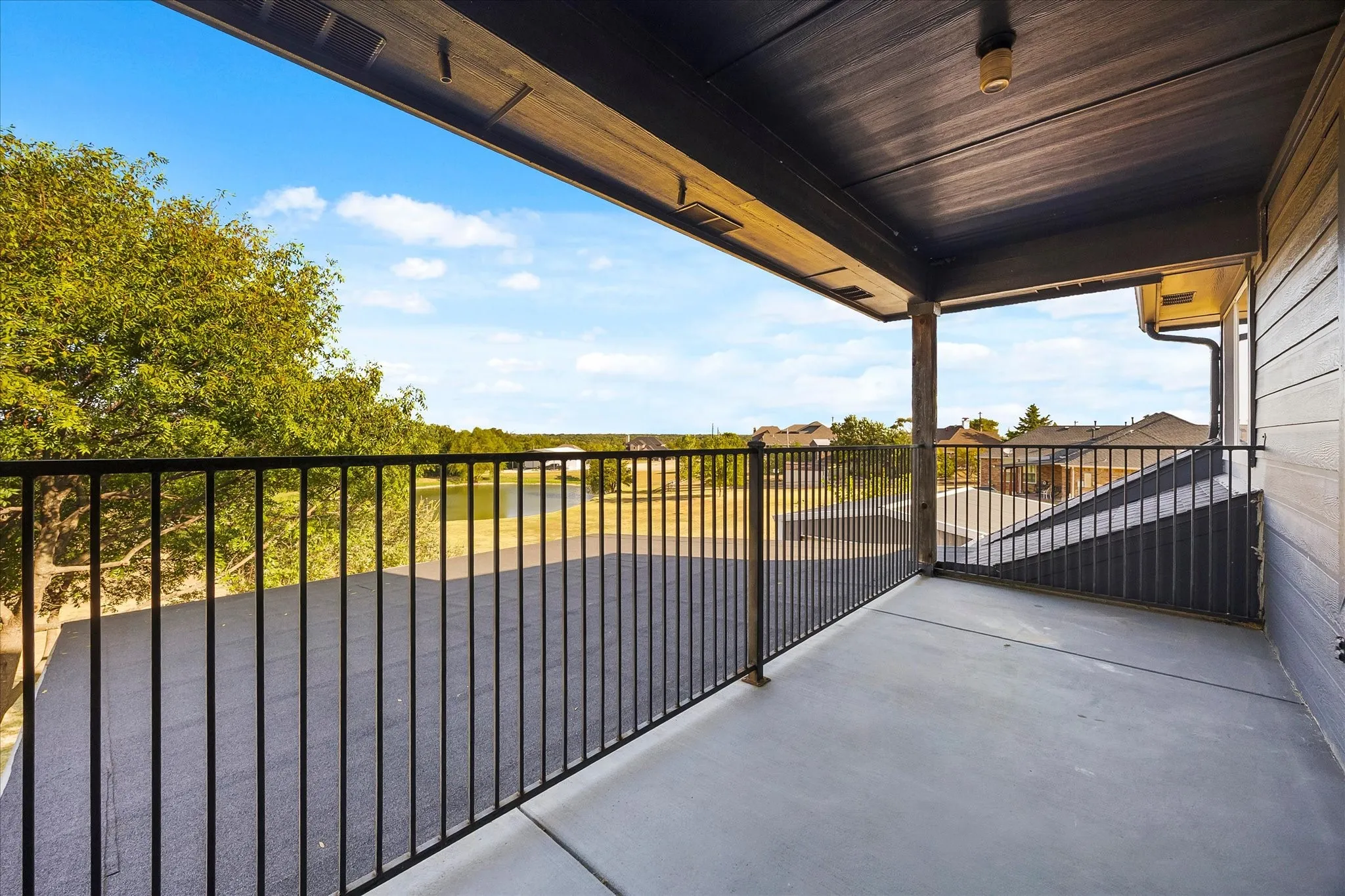 Covered balcony overlooks pond