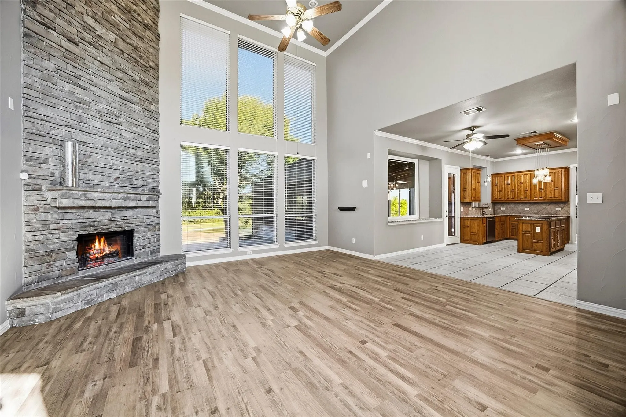 Incredible family room includes stunning stacked stone fireplace and banks of windows providing ample natural lighting!