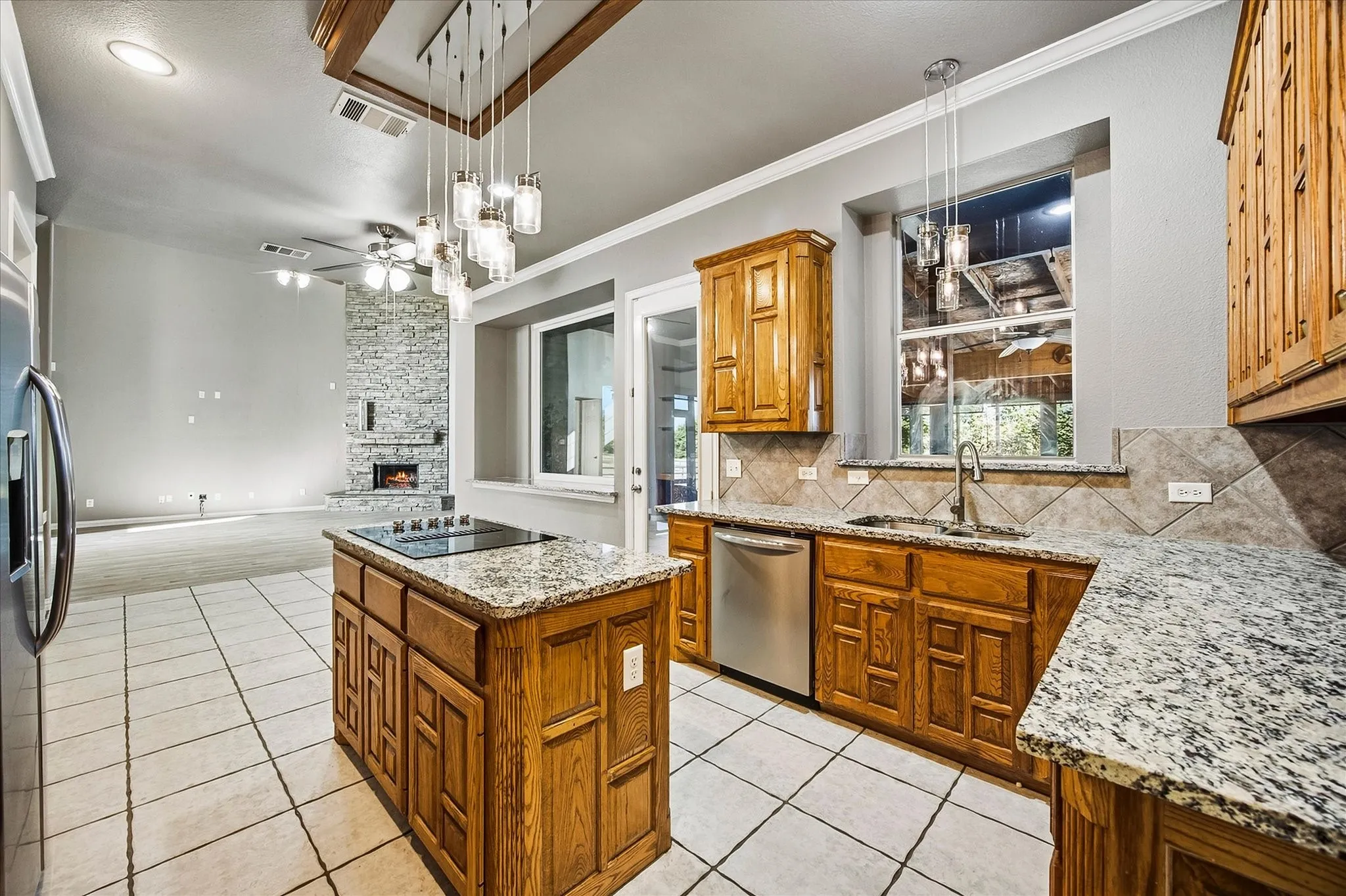 Open floor plan features family and dining area overlooking kitchen