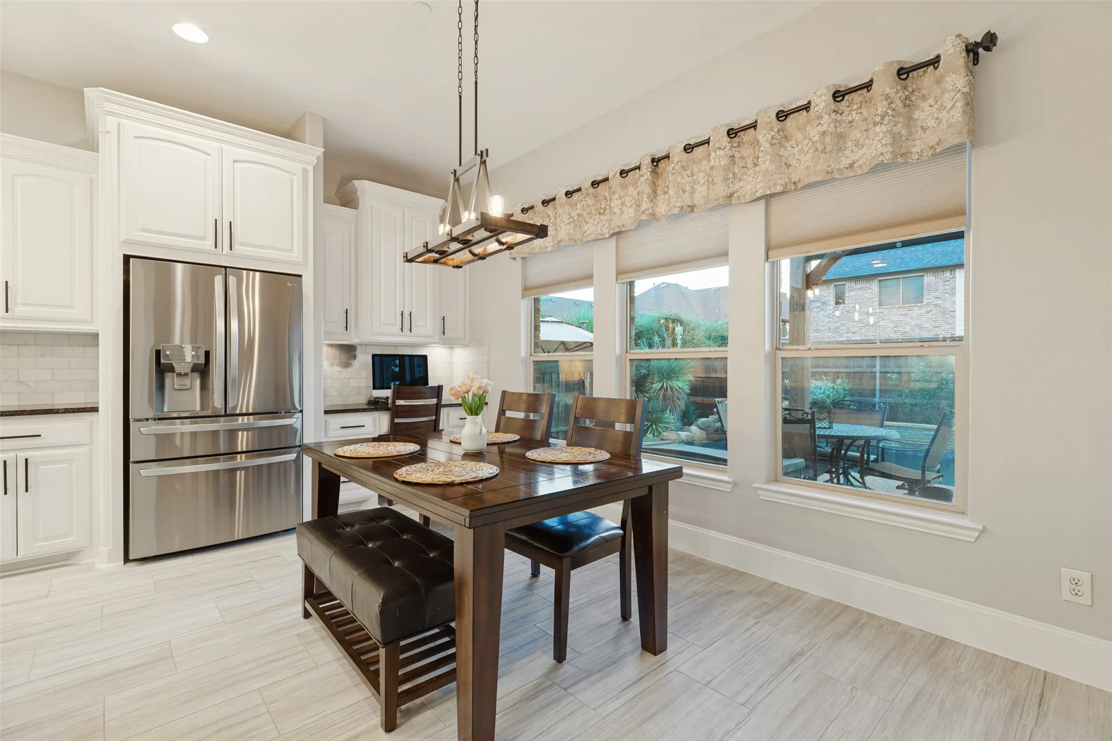 Kitchen dining space in addition to island seating. Desk area with cabinetry