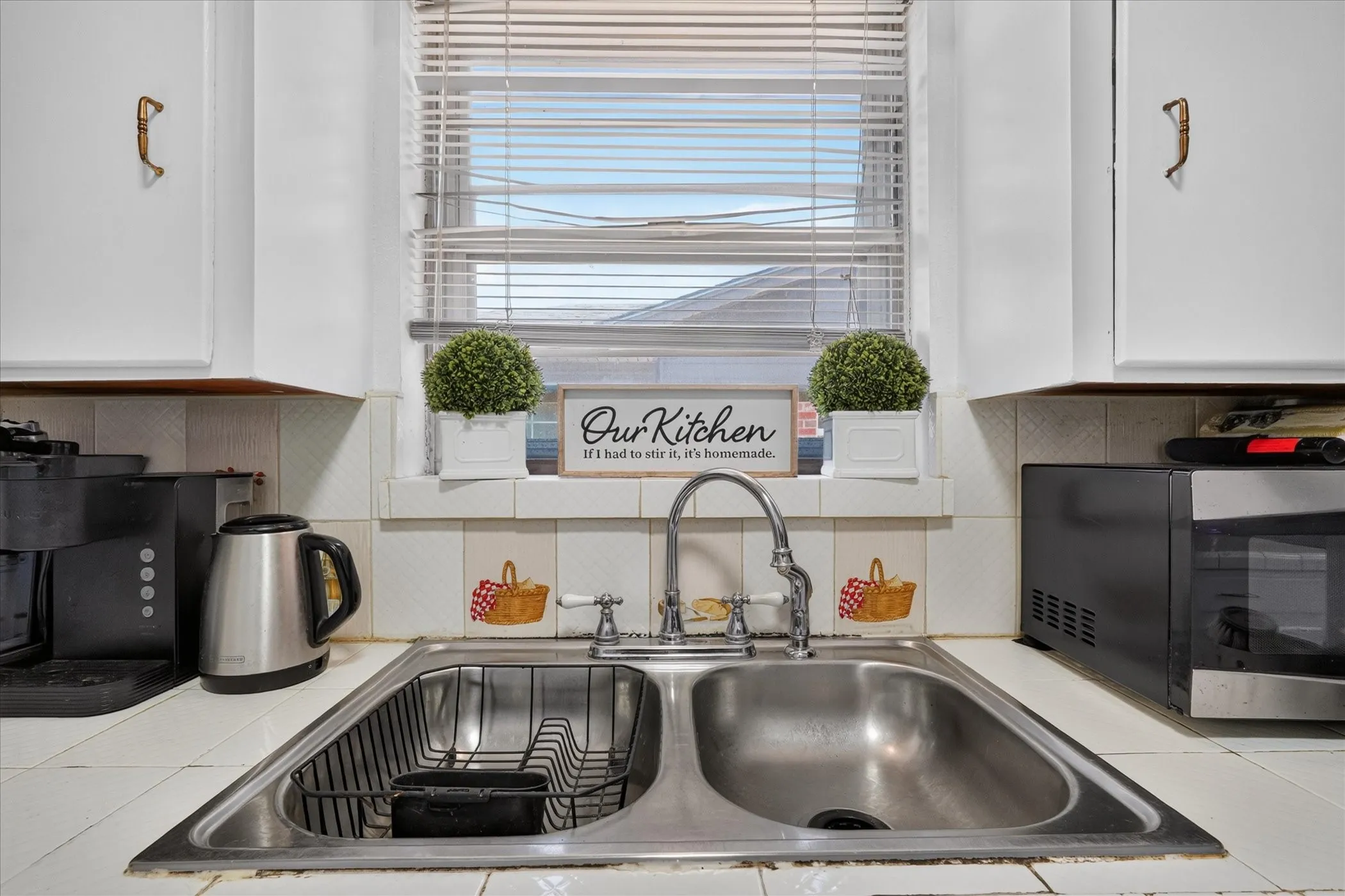 Stainless steel double basin sink with a chrome faucet