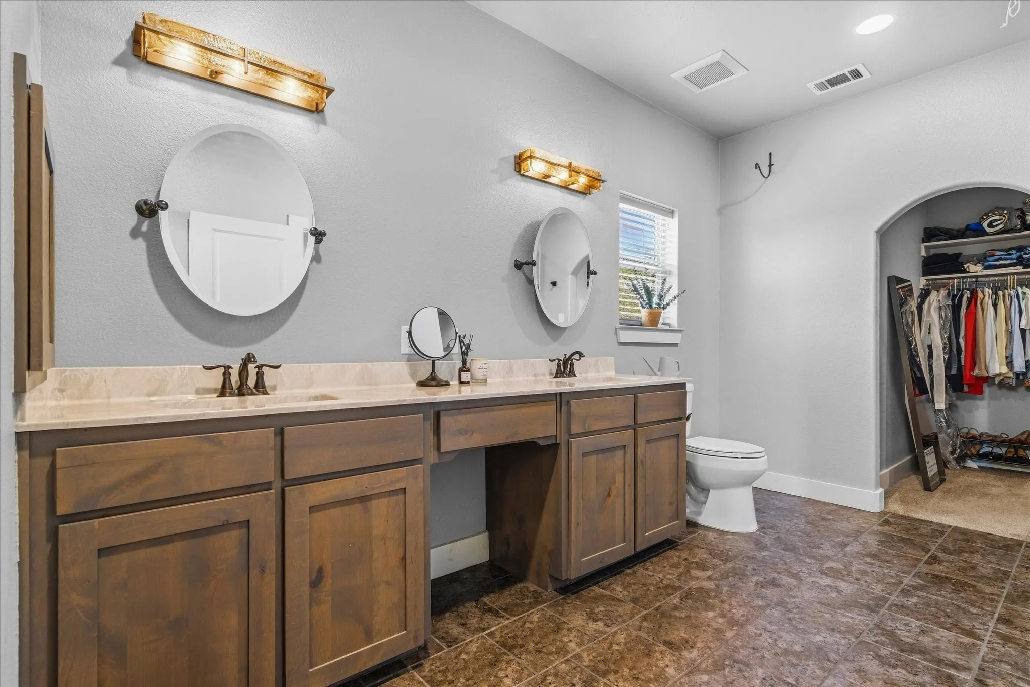 Dual vanities with integrated sinks and bronze-finish fixtures