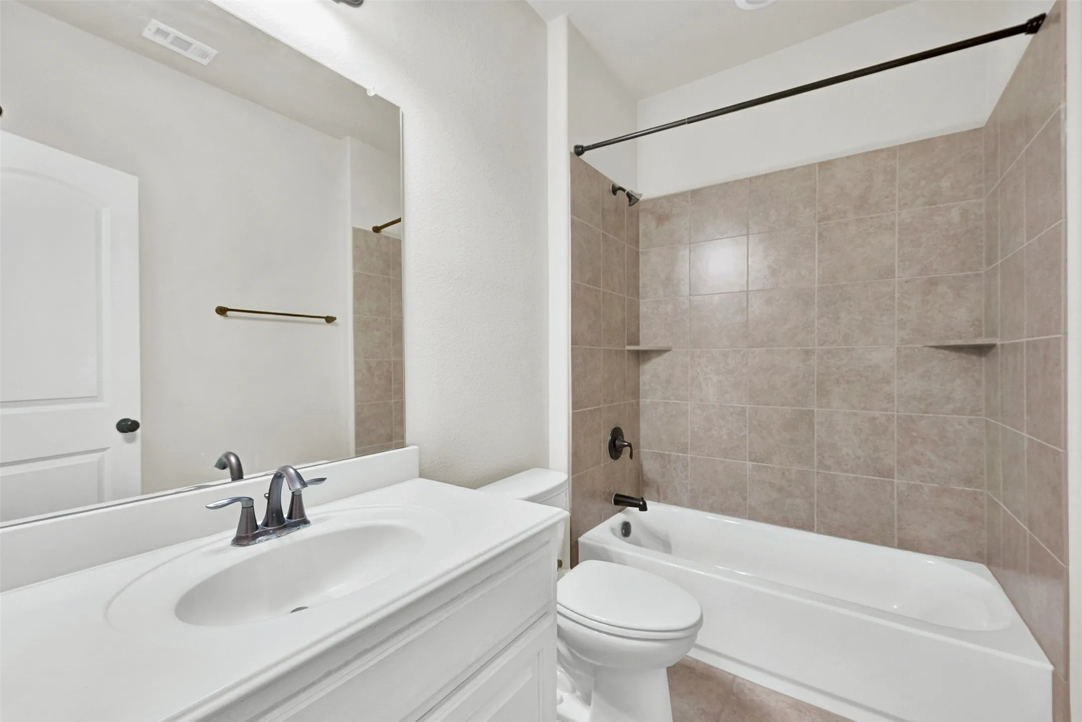 White vanity with an integrated sink and brushed nickel faucet