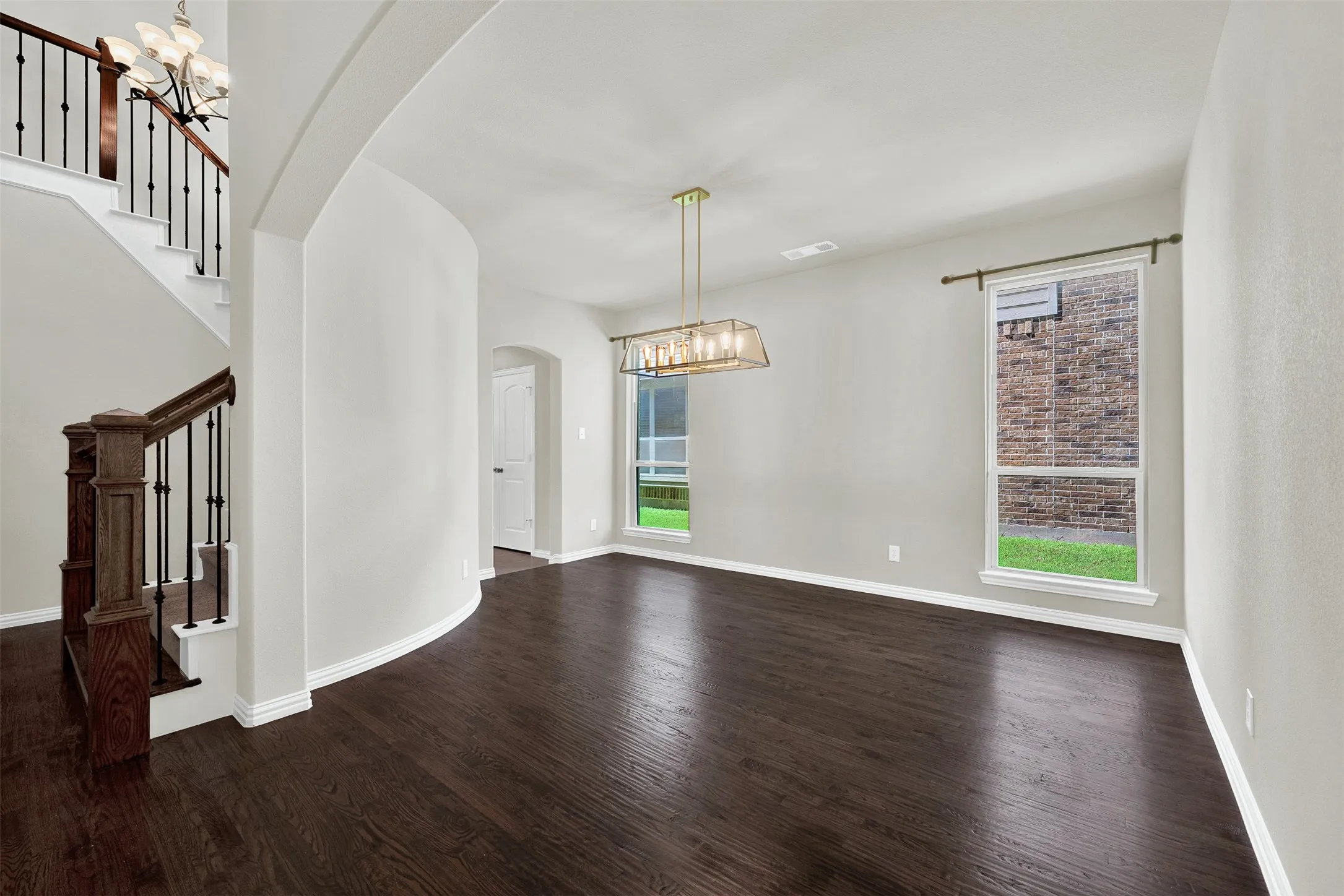 Rich wood-finish flooring with crisp white baseboards