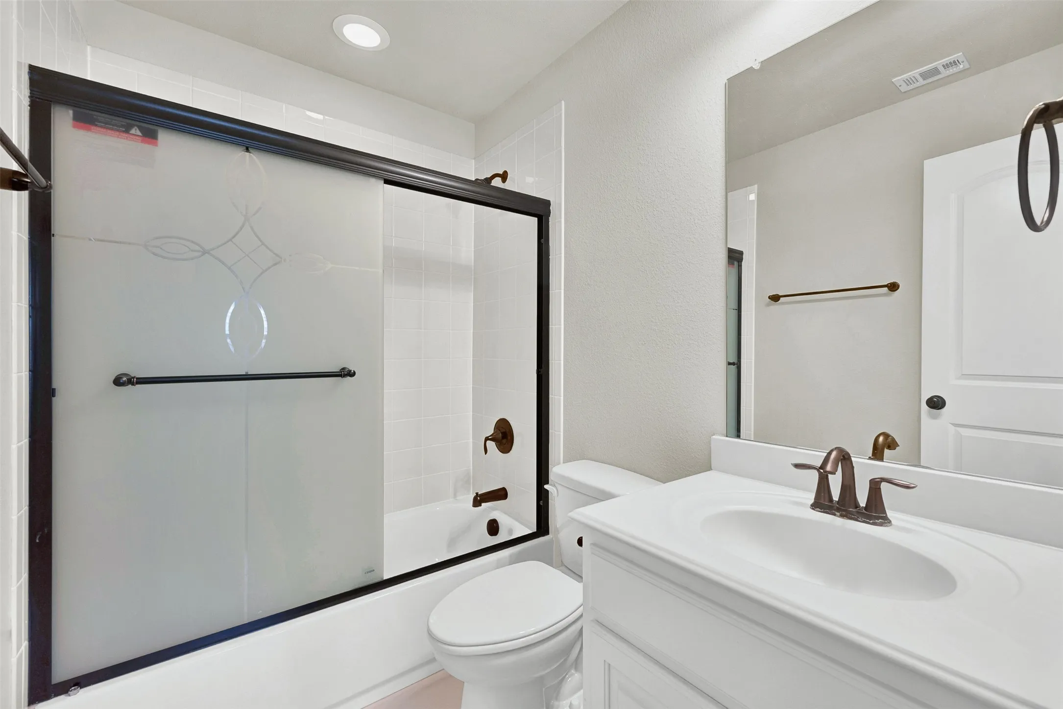 White vanity with an integrated sink and bronze-finish faucet