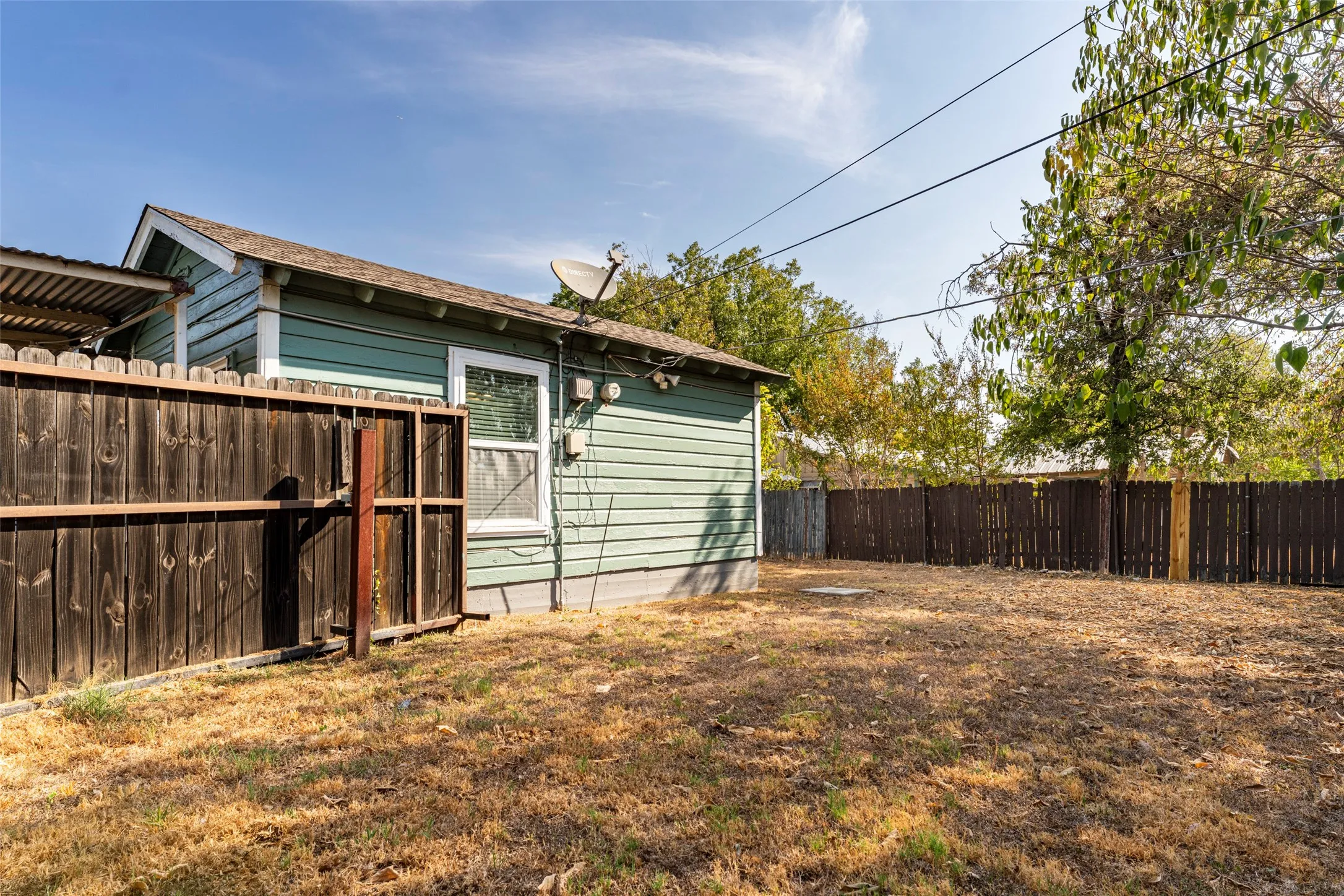 Expansive backyard featuring wood fencing and mature trees