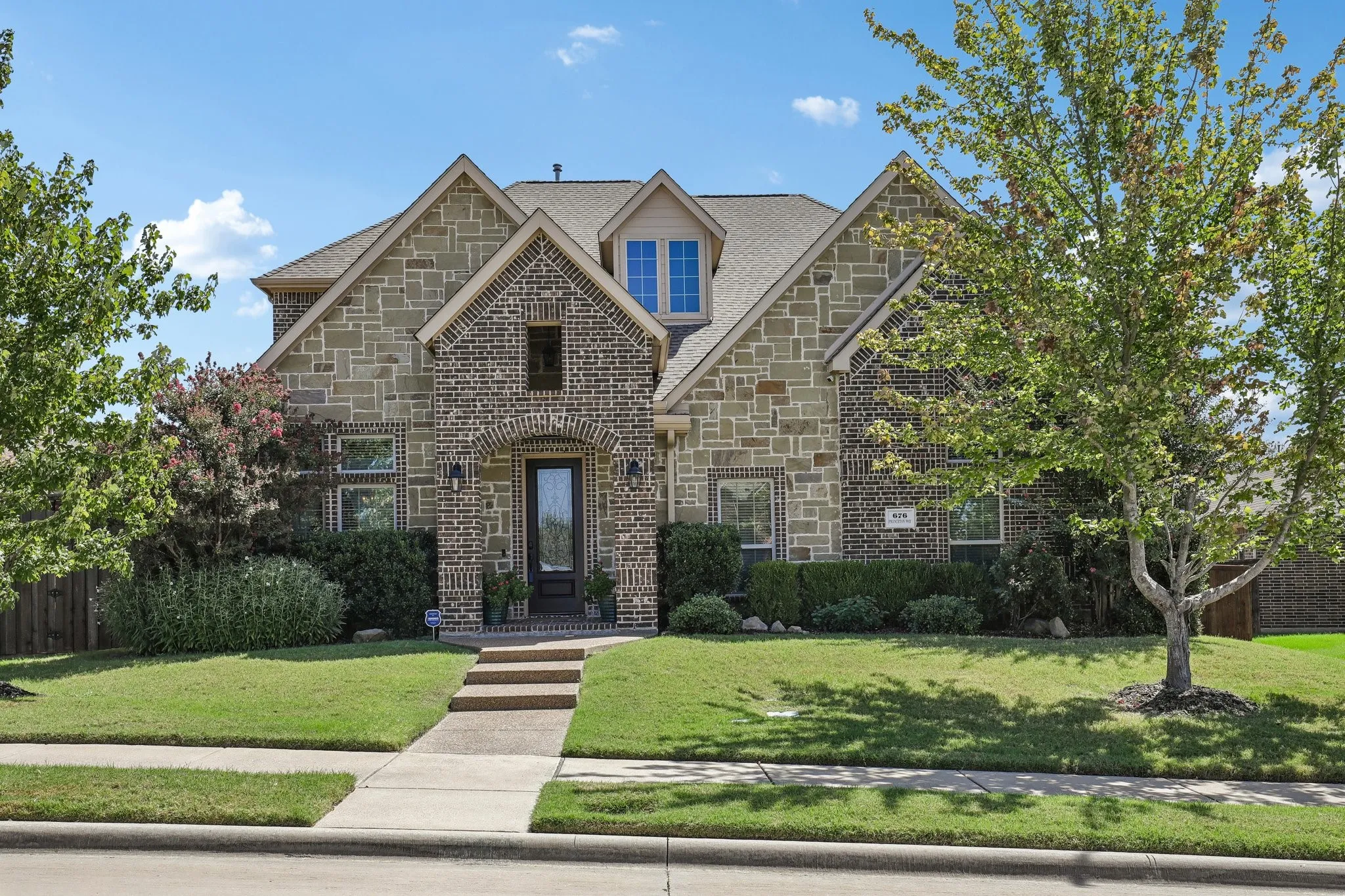 Stone and brick exterior with a prominent arched entry