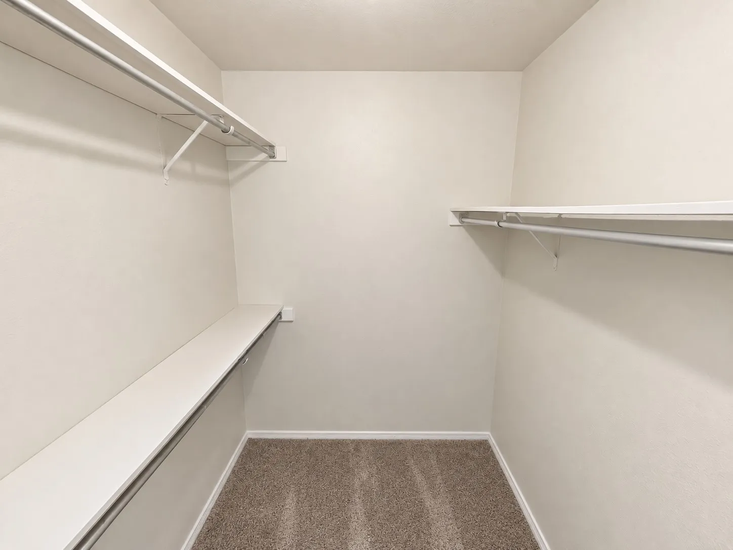 Neutral-toned walls complement the brown carpeted flooring