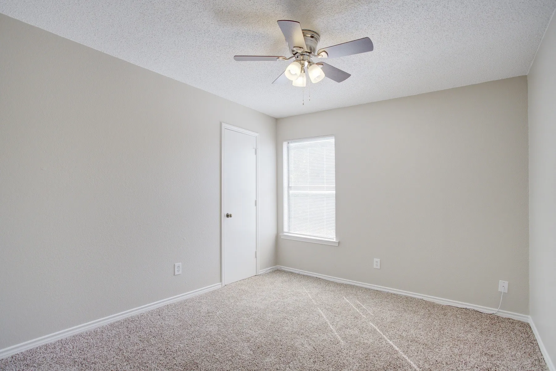 Neutral-toned walls with carpet flooring
