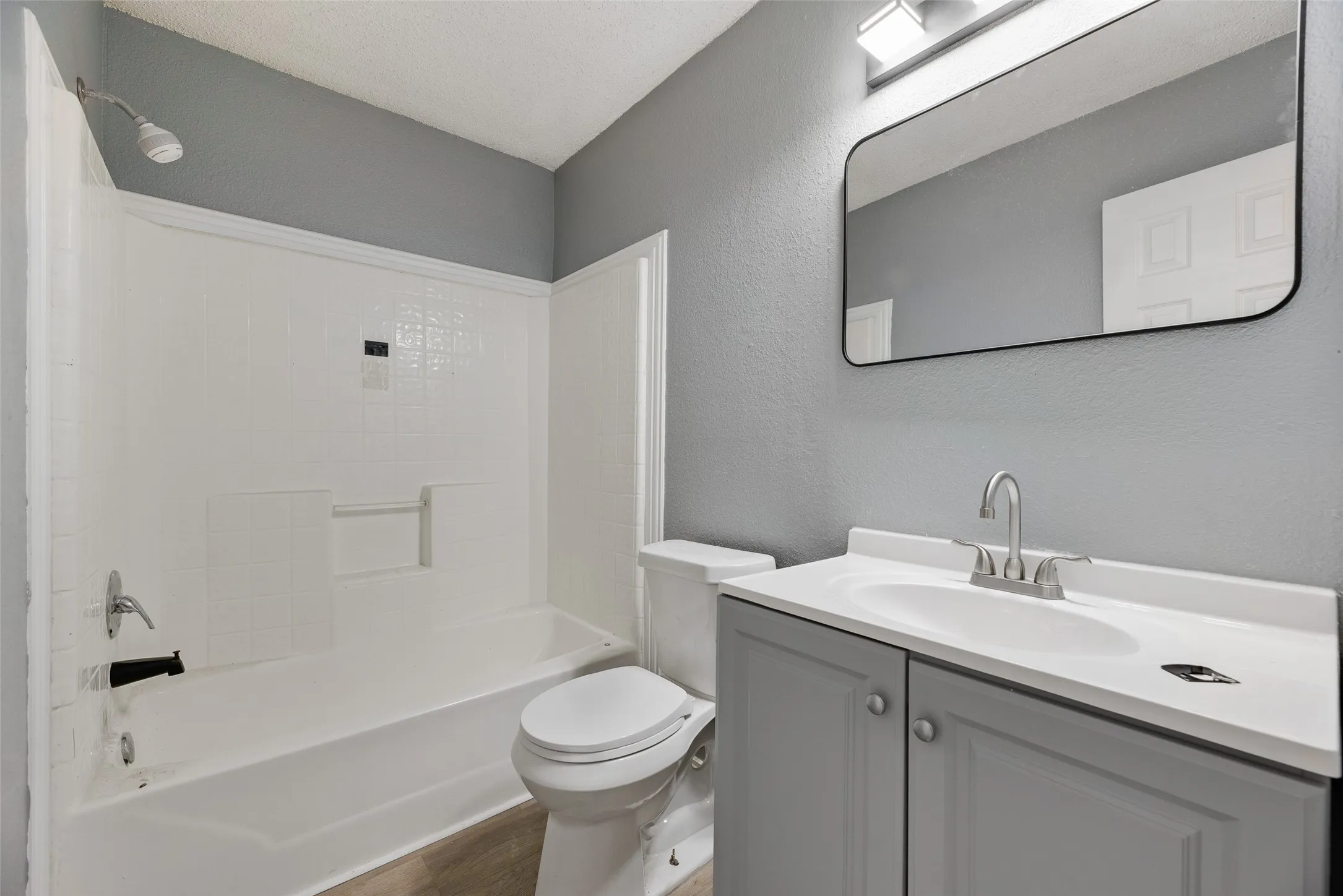 White tub and shower combination with a single-handle faucet