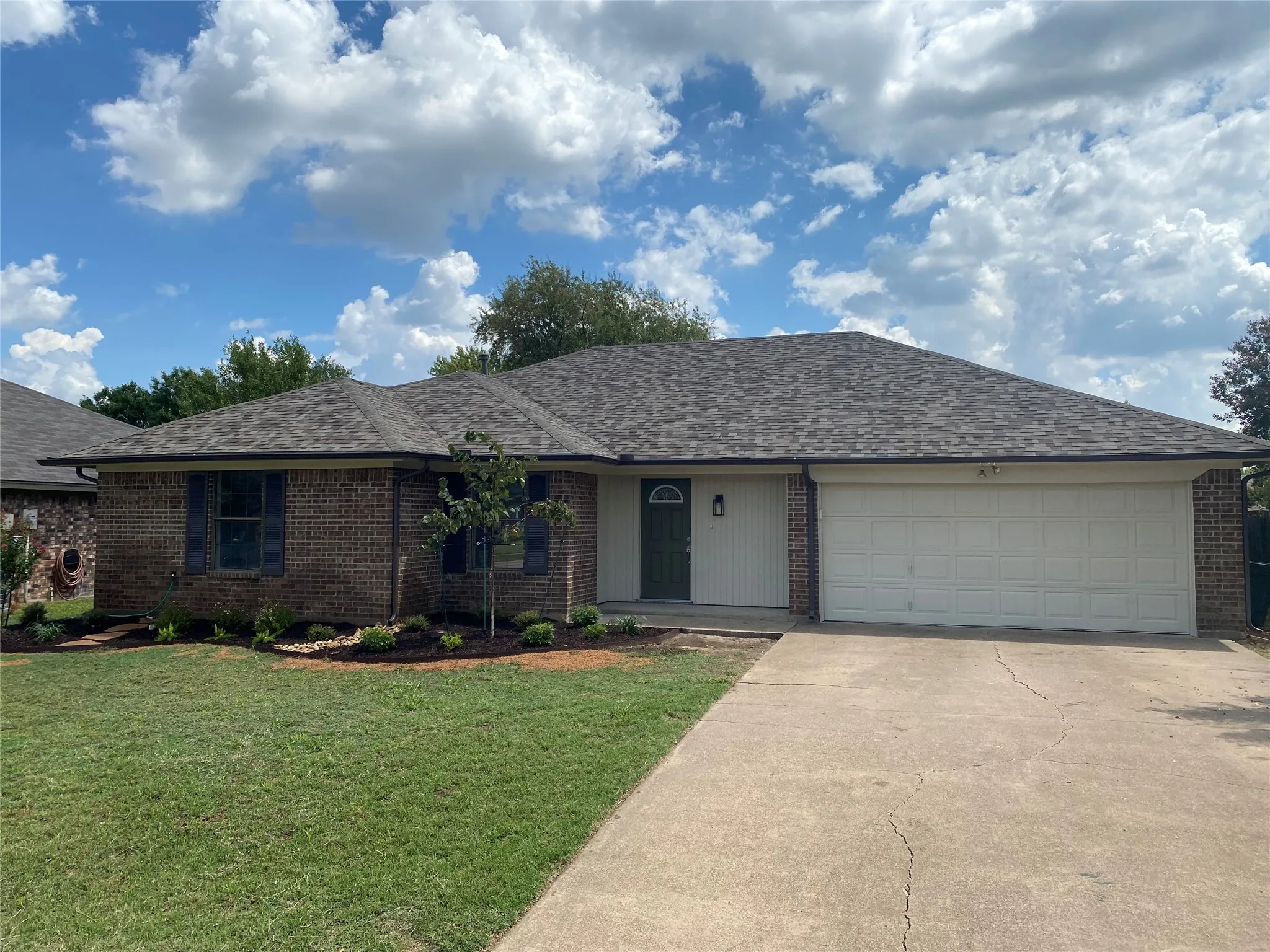 Brick and siding exterior with a shingle roof