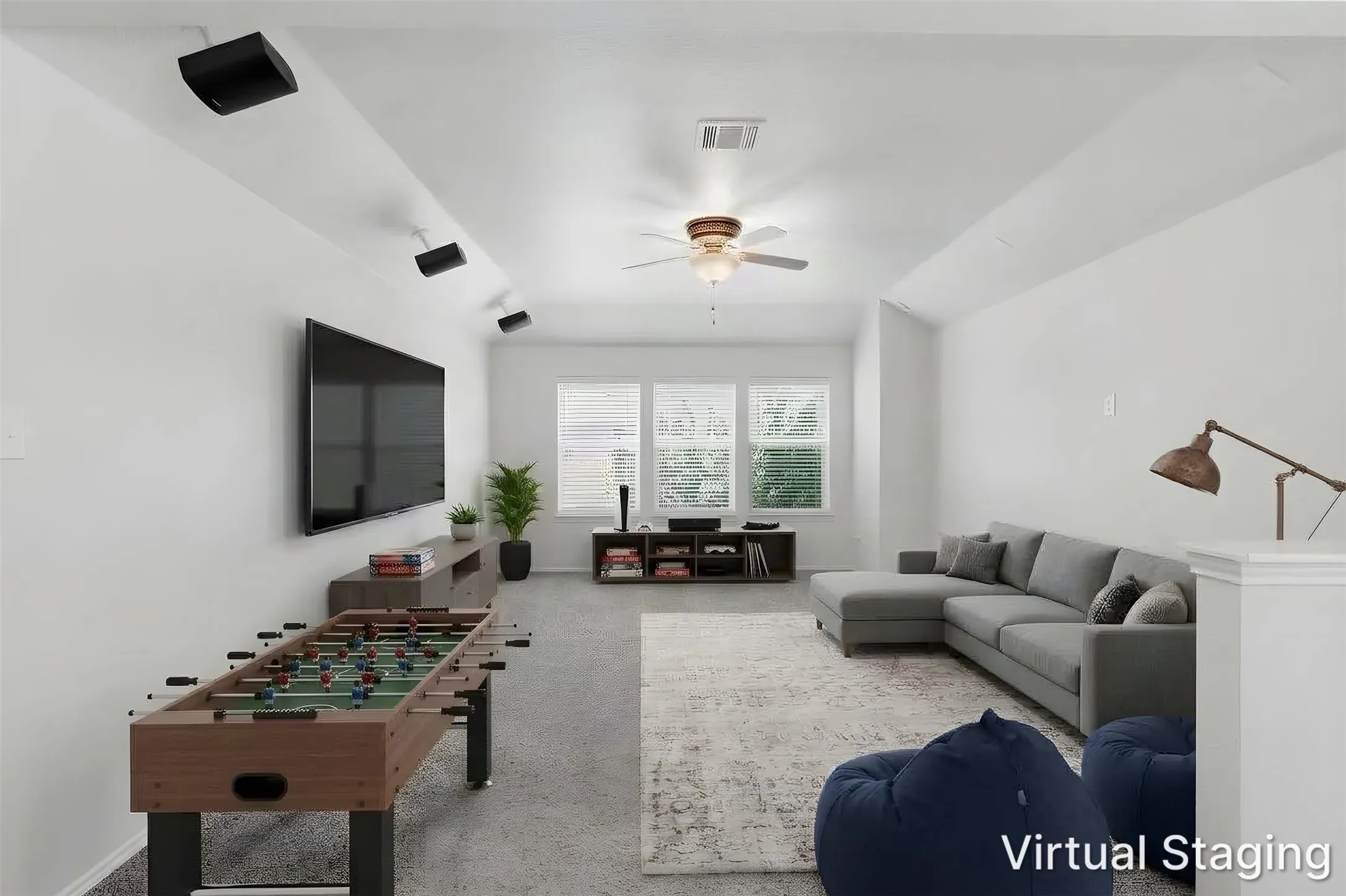 Large game room with ceiling fan and multiple windows with blinds