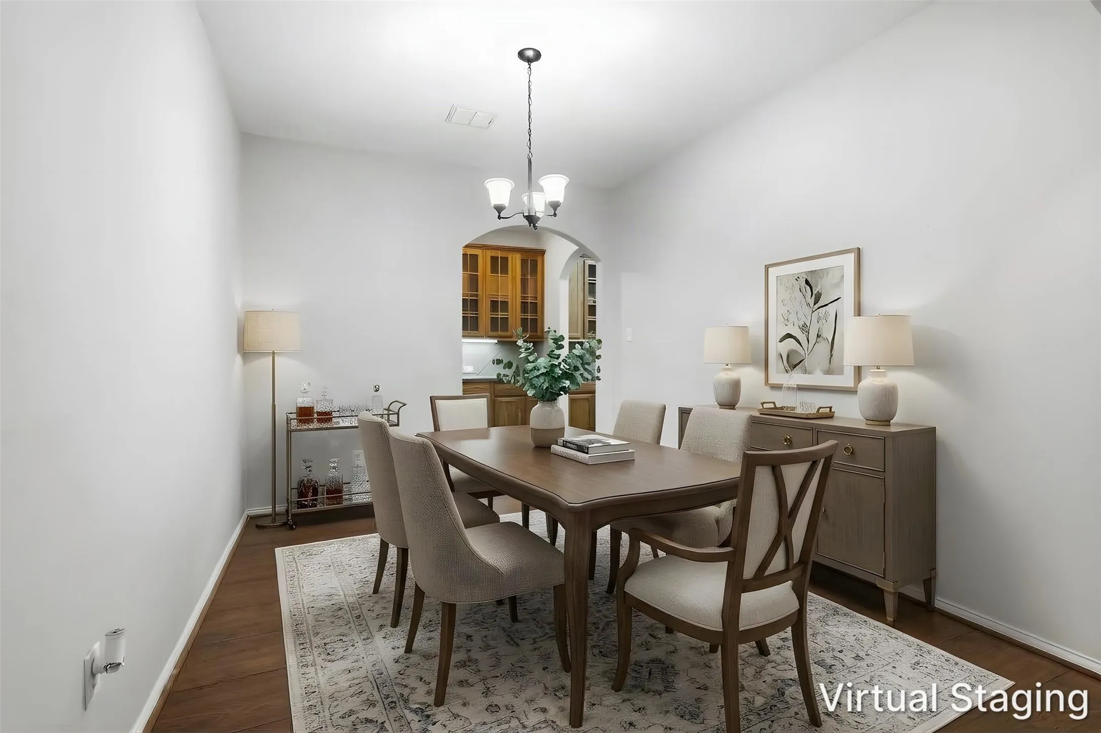 Wood-finish flooring, pendant lighting, arched doorway, and a ceiling-mounted light fixture