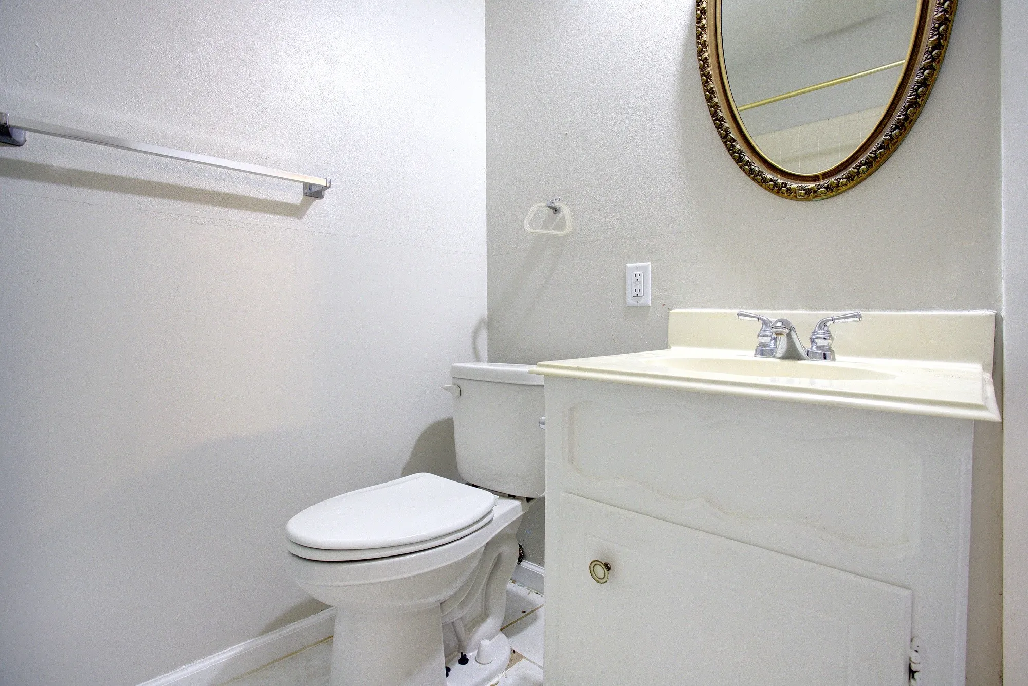 White vanity with a single basin sink and chrome faucet
