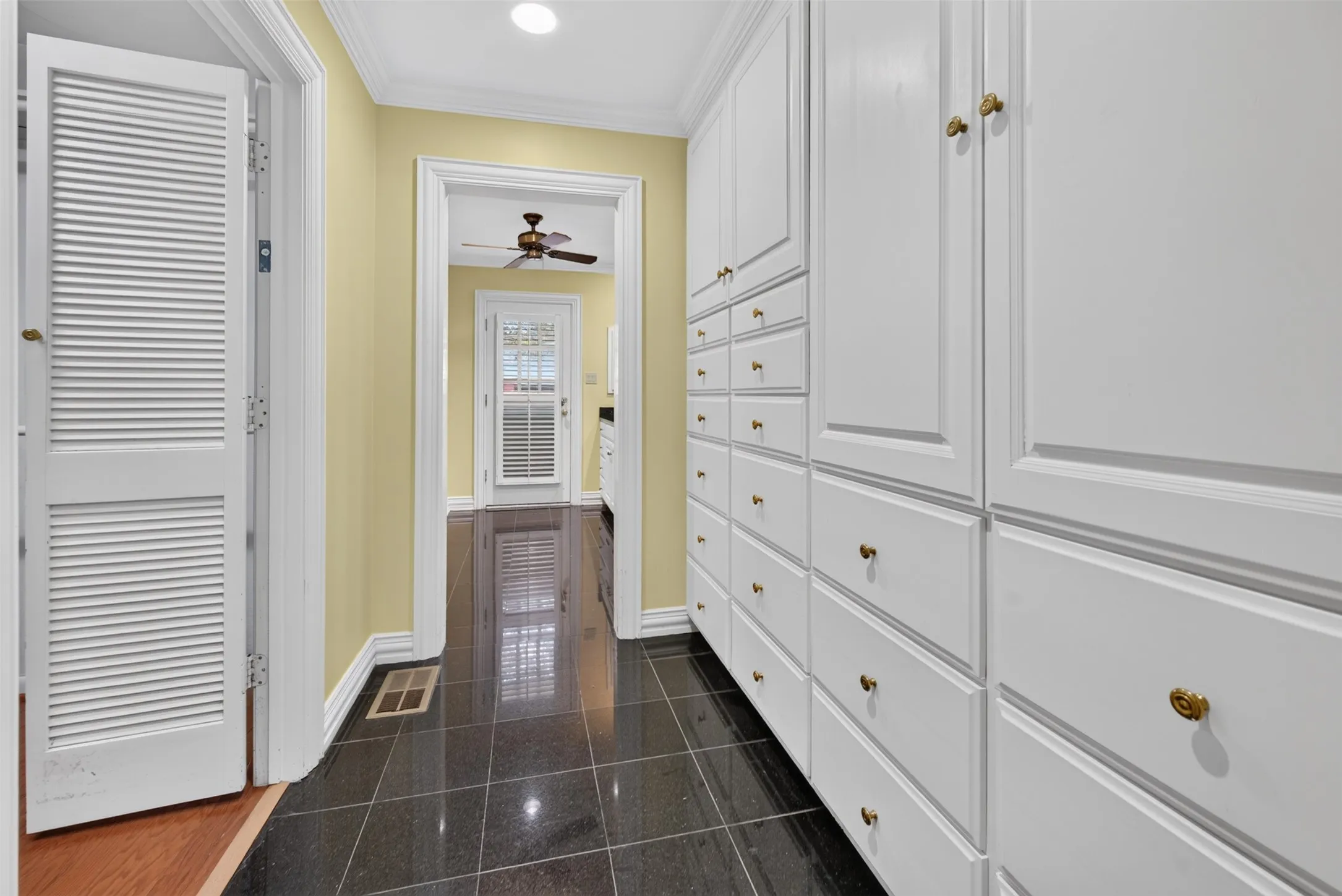 Built-in white cabinetry with brass-toned hardware