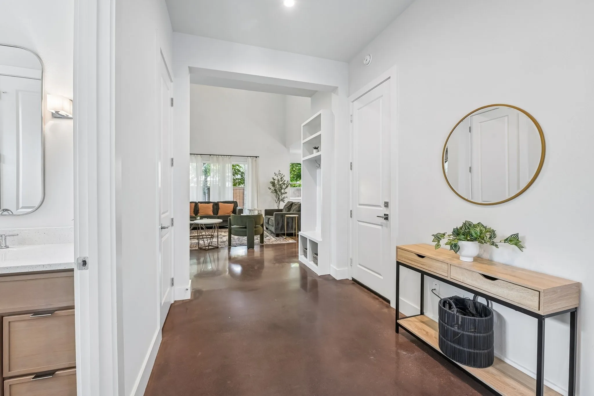 Hallway featuring polished concrete flooring, white walls, and a recessed ceiling light