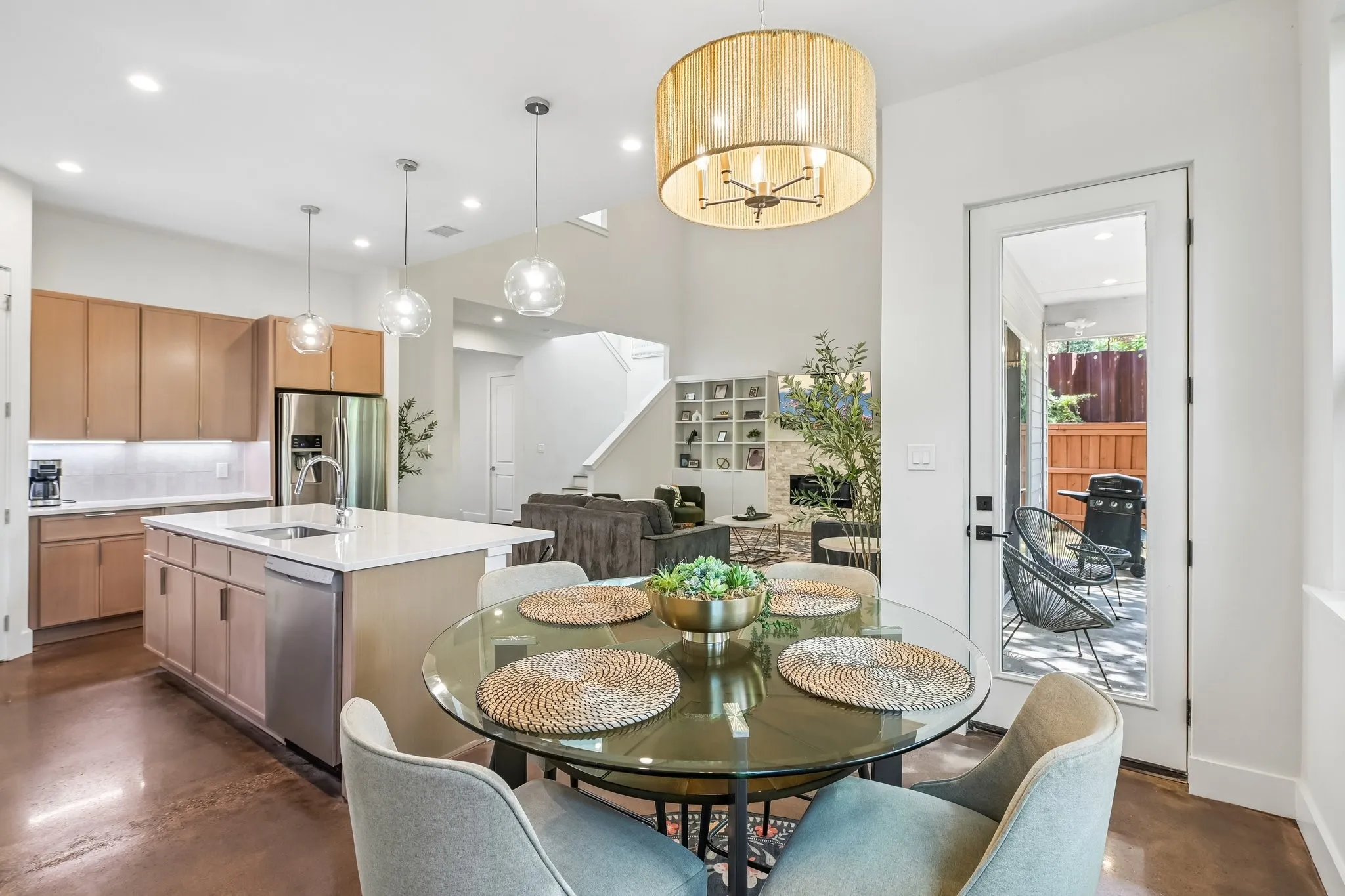 Open concept living area with high ceilings, recessed lighting, and wood-finish flooring