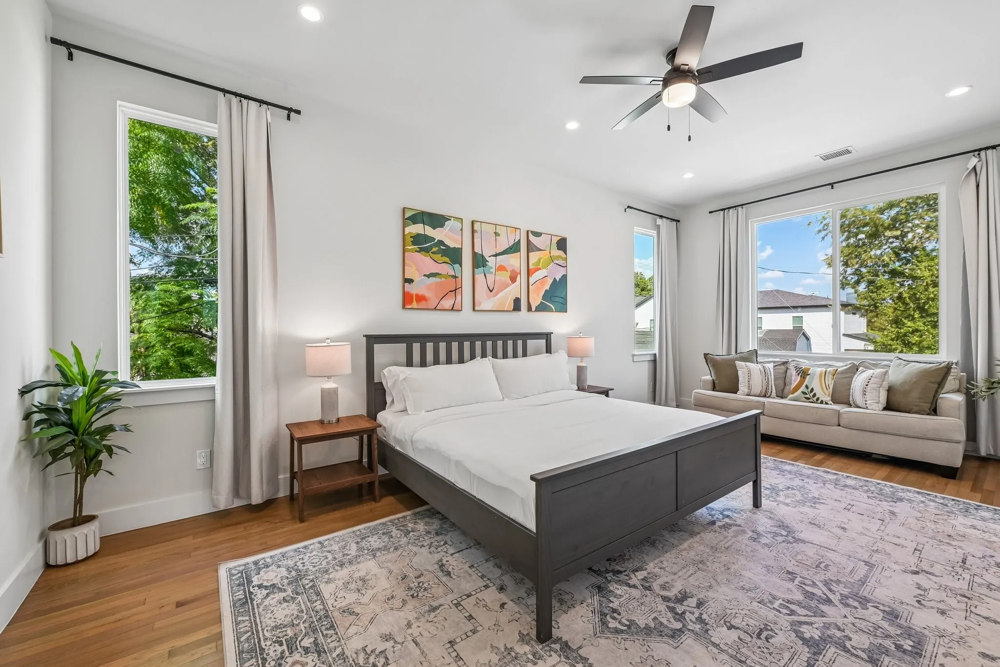 Bright room with hardwood flooring, recessed lighting, and a ceiling fan