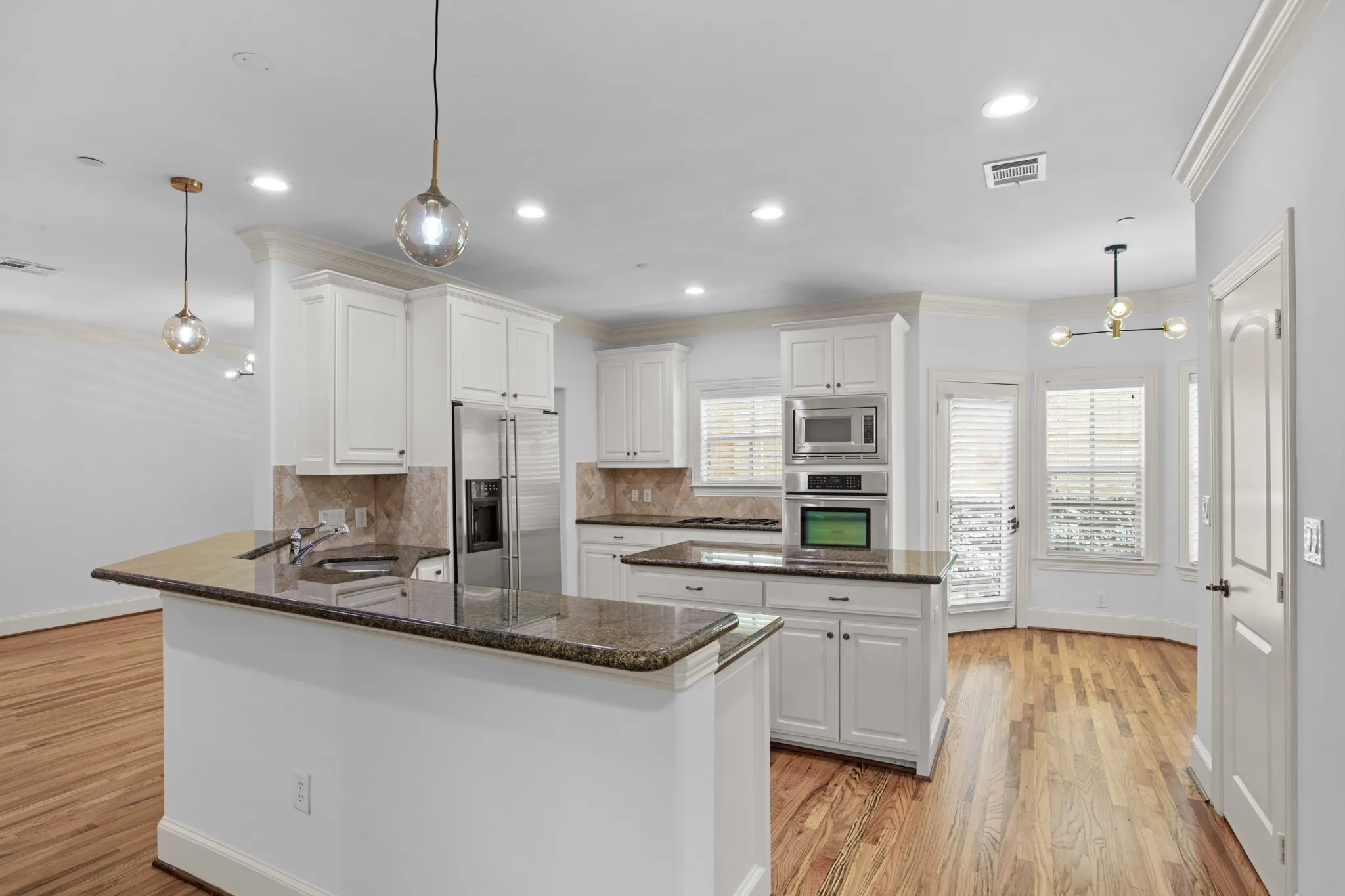 Kitchen with SS appliances, refrigerator, double oven, microwave, dish washer, wine fridge