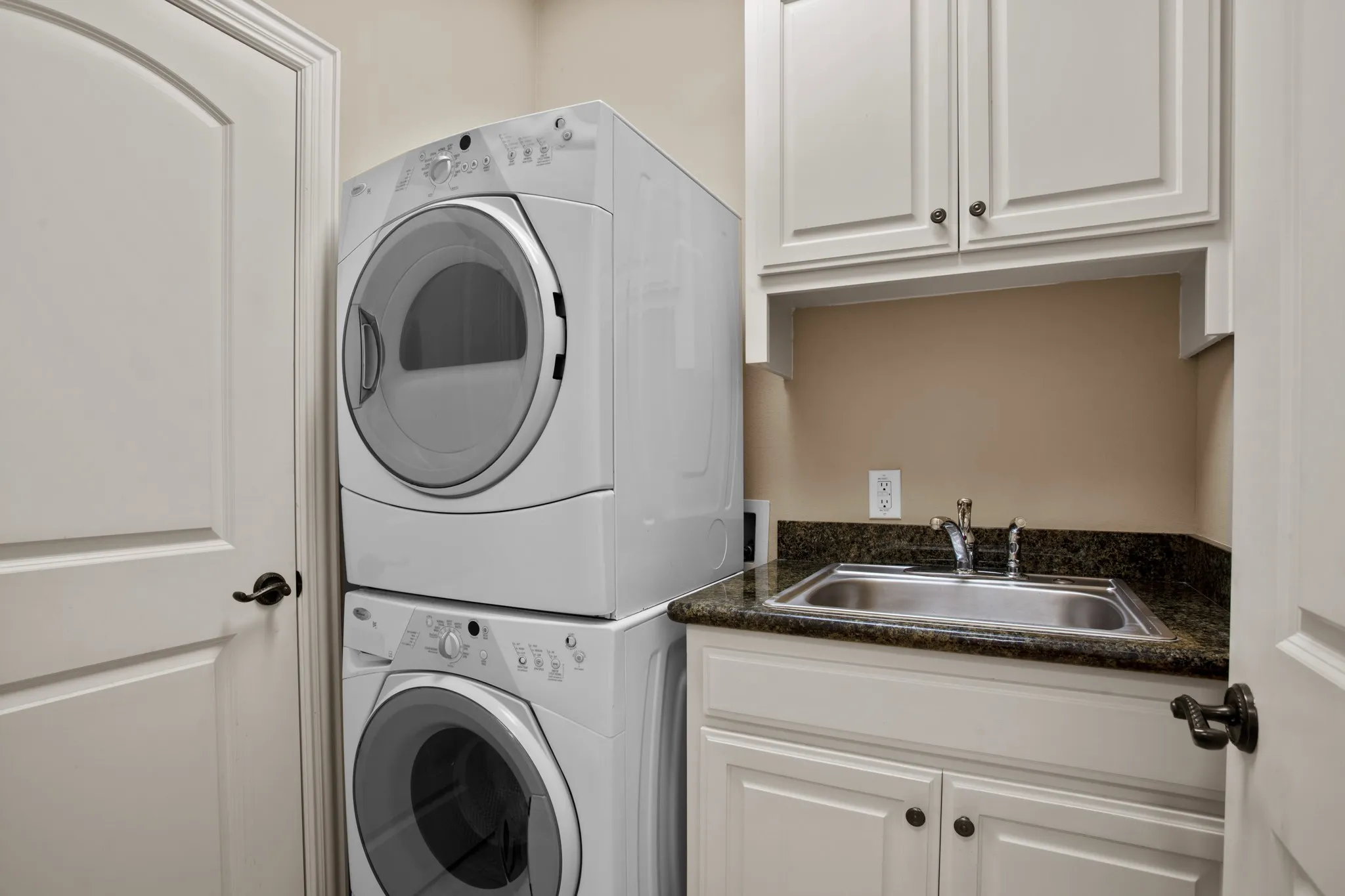 Laundry area with stacked washer and dryer