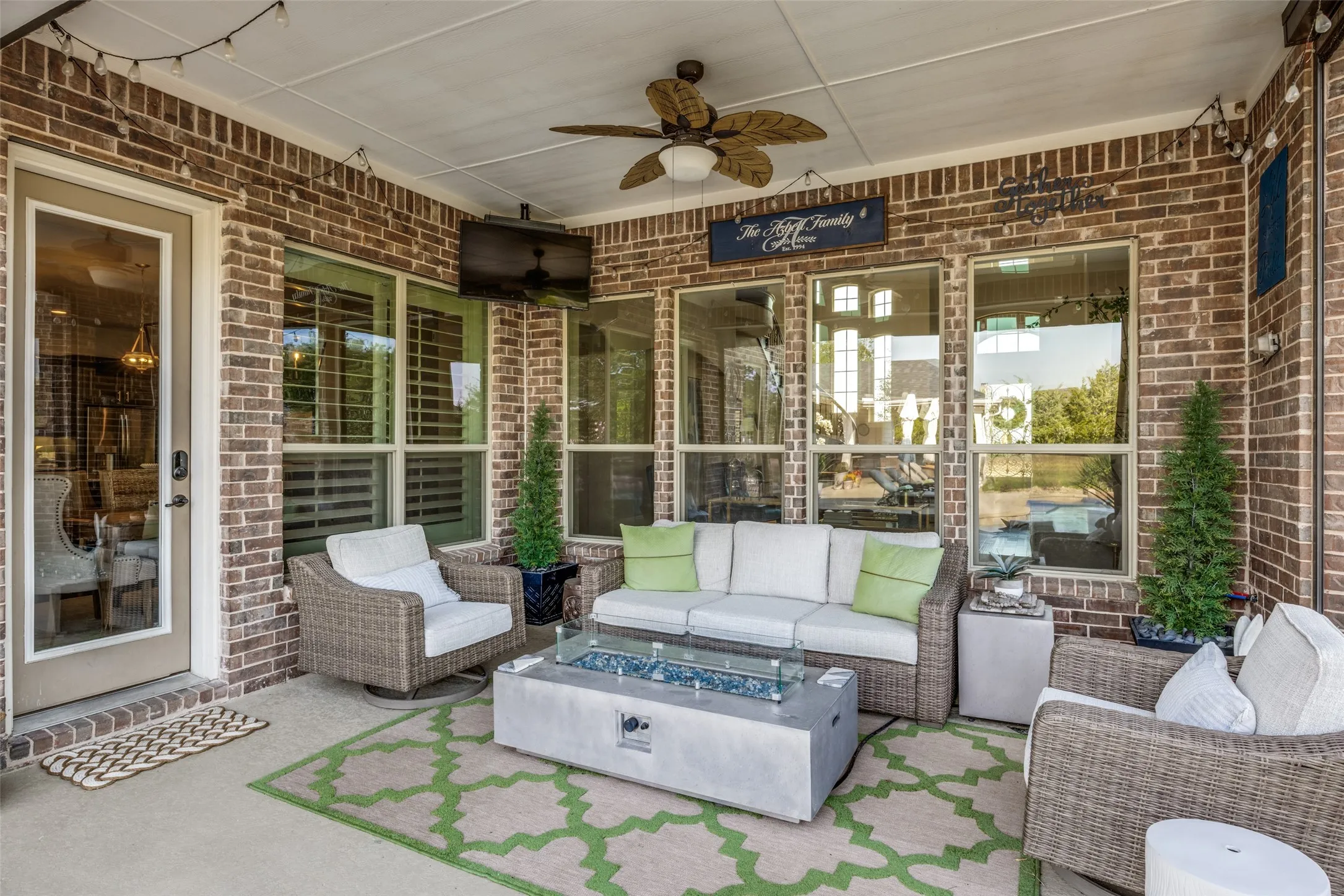 Covered patio outside back door has motorized shade enclosure if desired