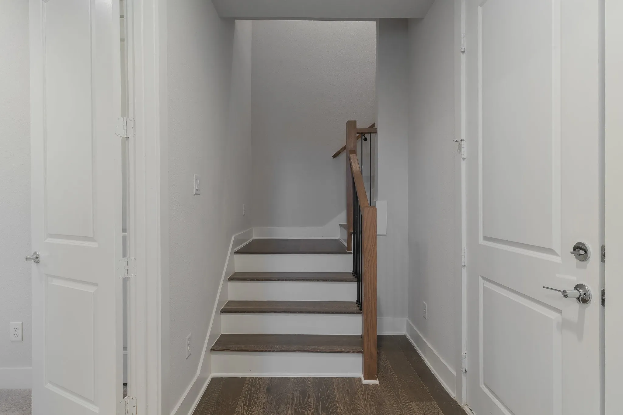 Staircase with baseboards and wood finished floors