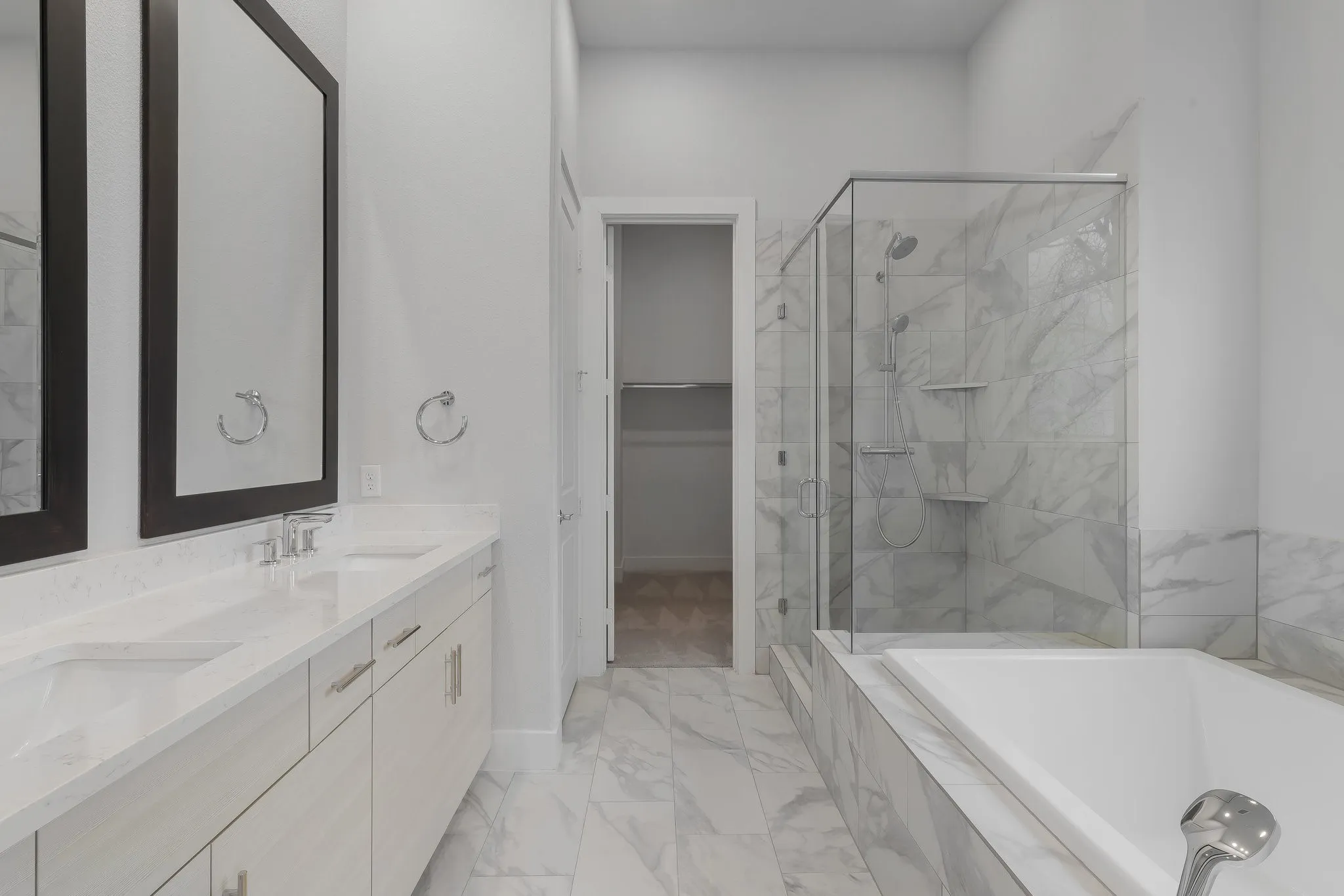 Full bathroom with marble finish floor, a sink, and a stall shower