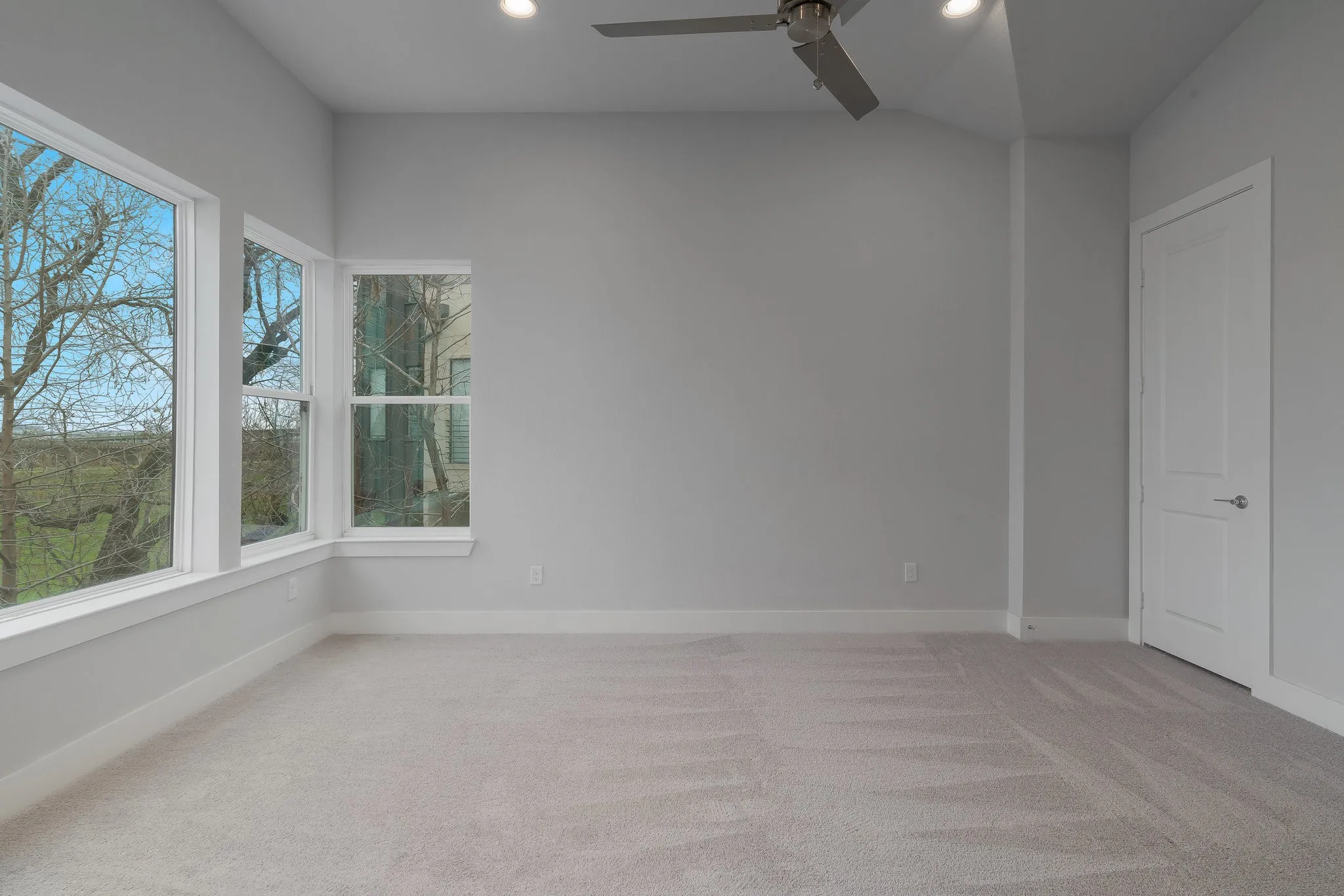 Empty room with recessed lighting, carpet floors, baseboards, and ceiling fan