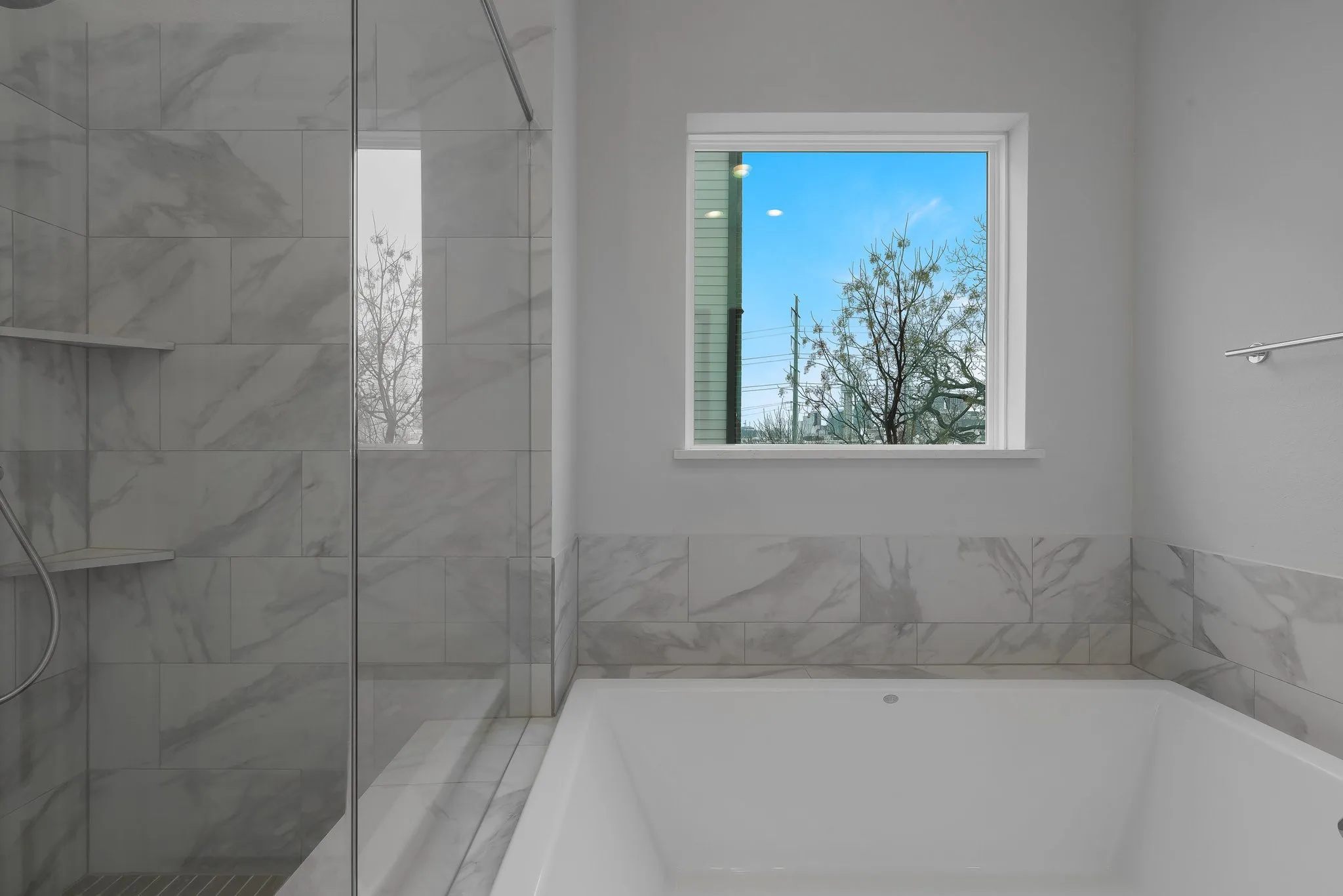 Bathroom with a tile shower and a garden tub