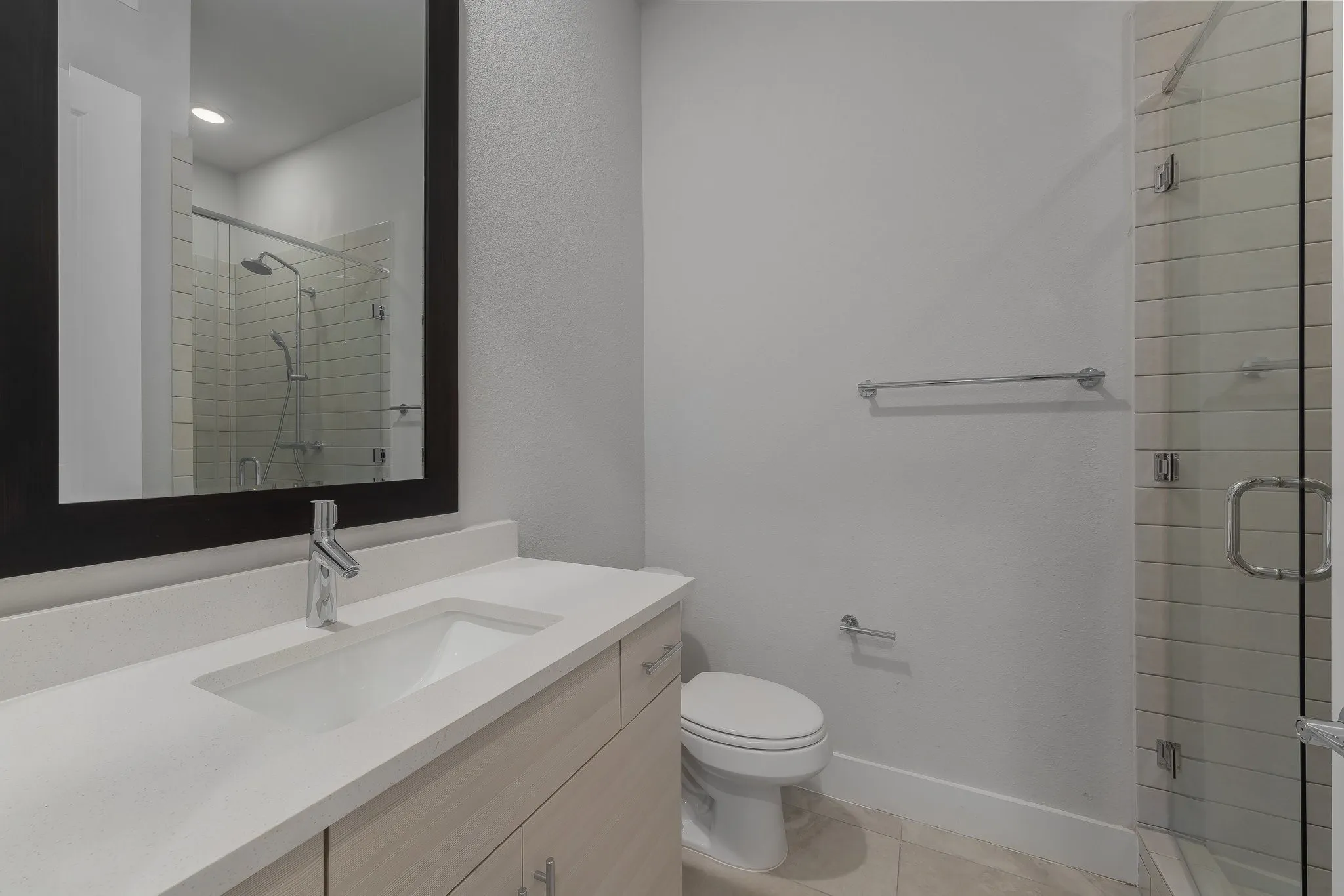 Bathroom with vanity, tile patterned flooring, a shower stall, and toilet