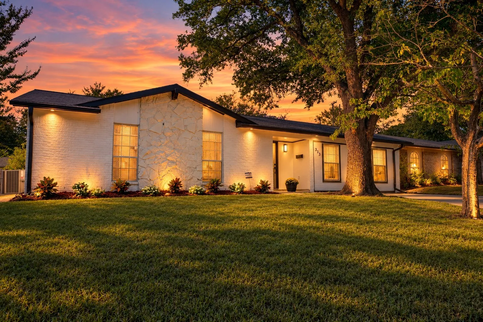 White brick exterior with stone accents and a dark roof