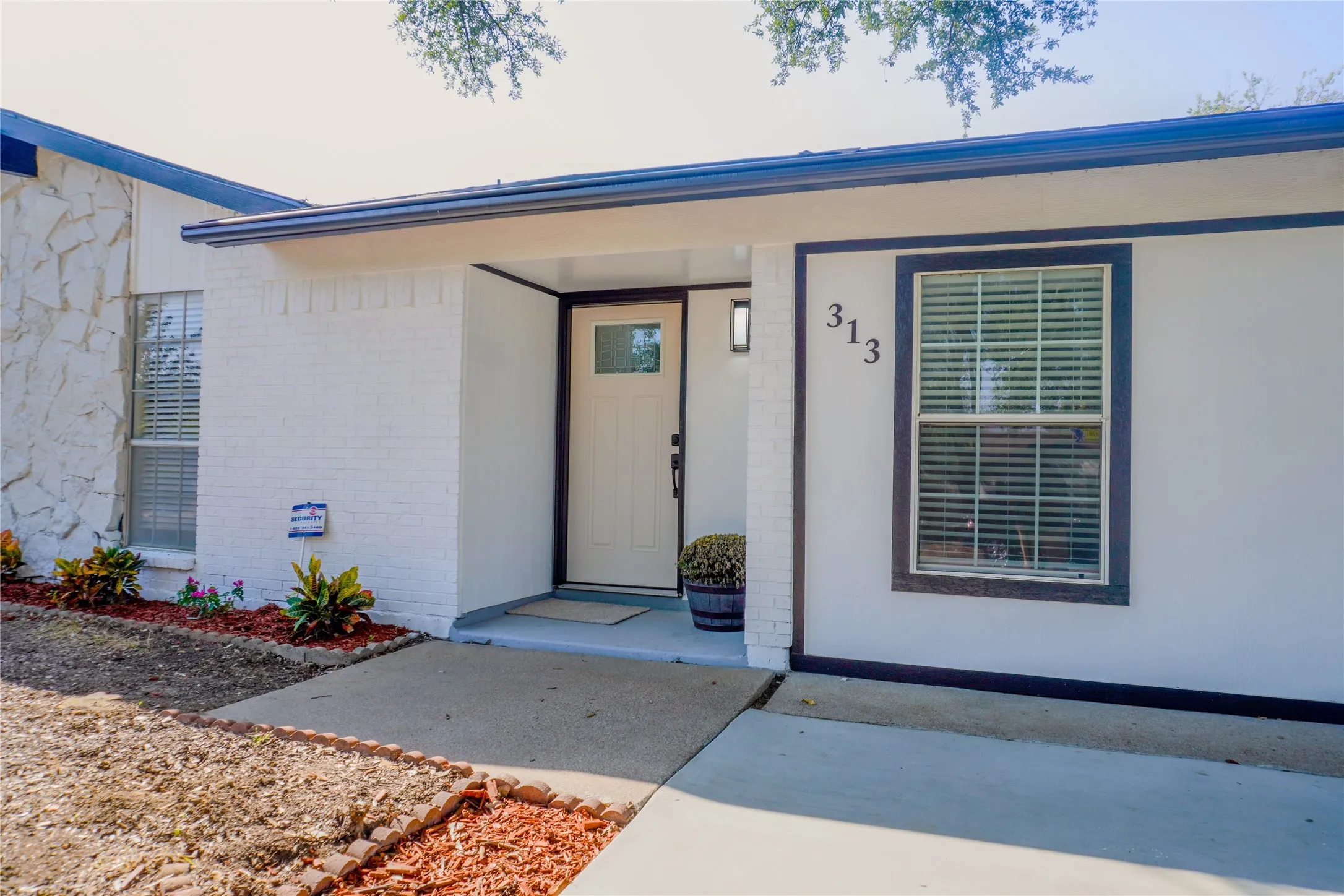 White painted brick exterior with dark trim accents