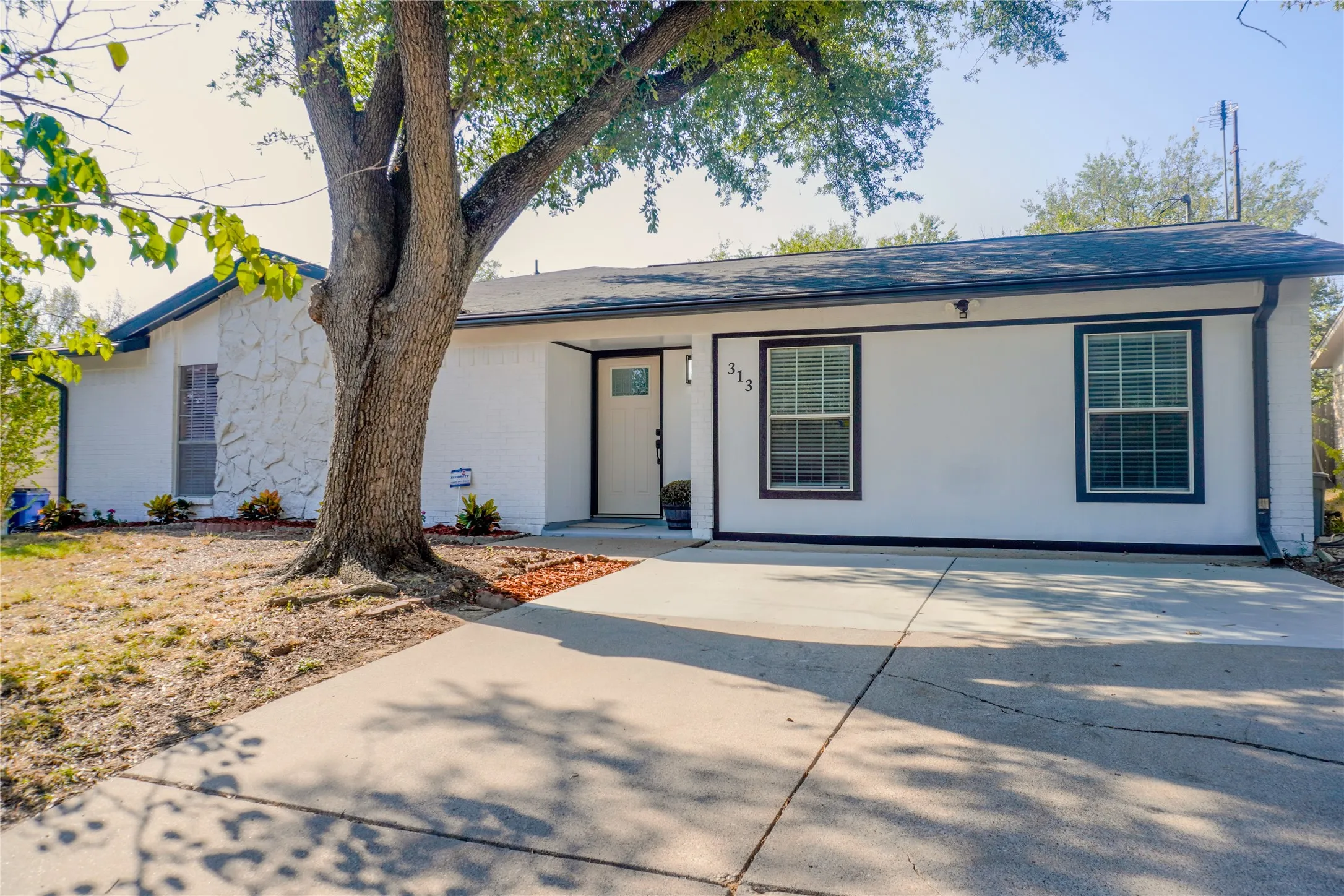 White exterior with dark trim and a dark roof