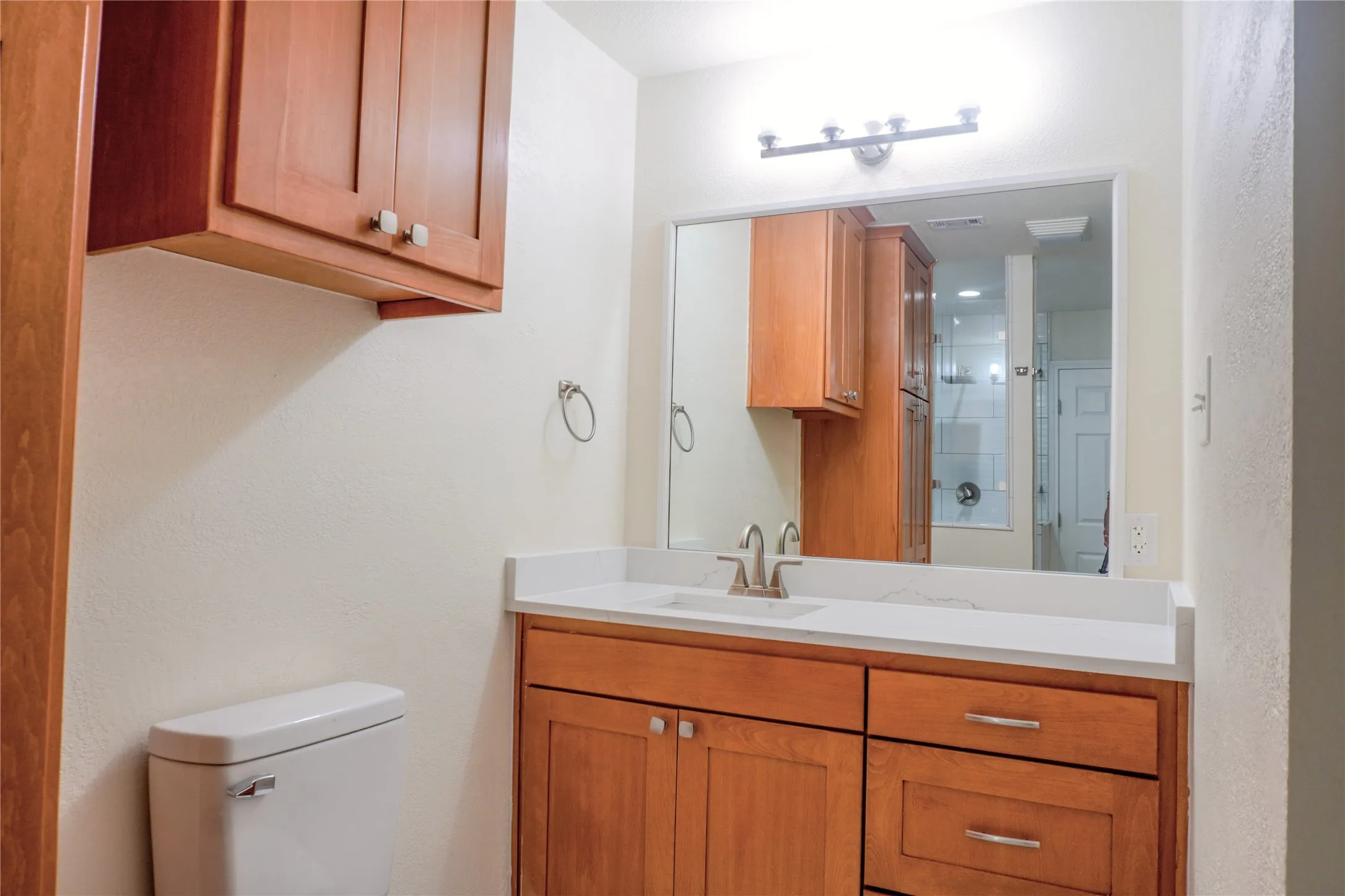 White countertop with an integrated sink and brushed nickel faucet
