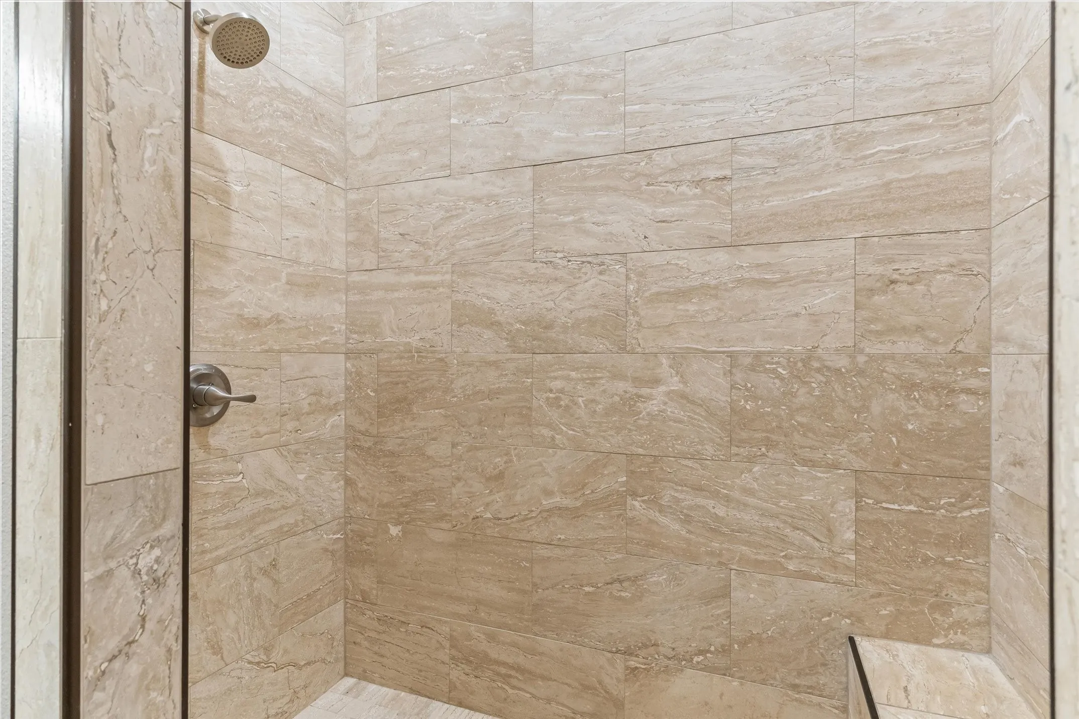 The master suite's large walk in shower with a seat is a must see