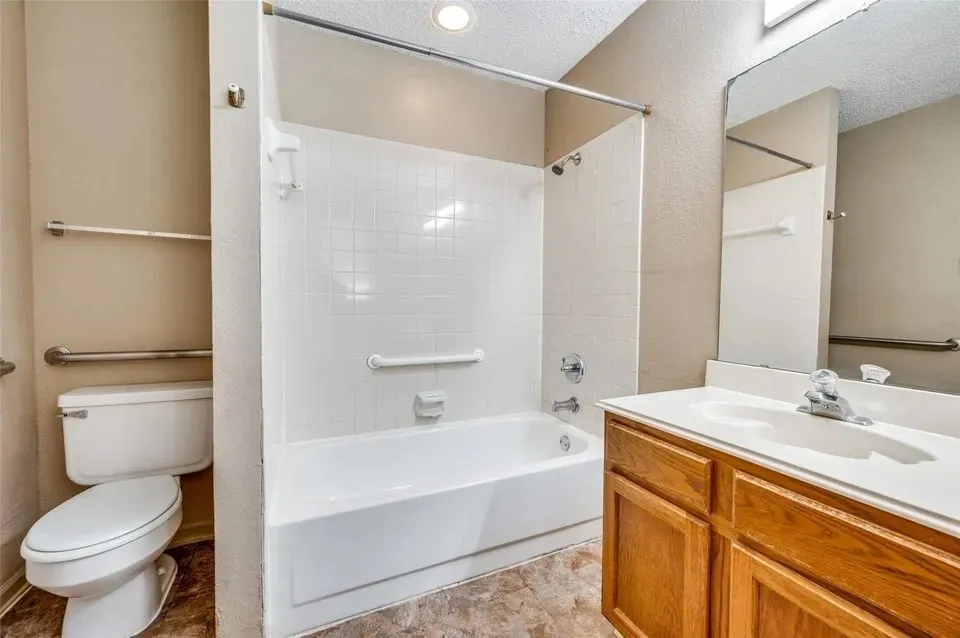 White tiled shower and bathtub combination with chrome fixtures