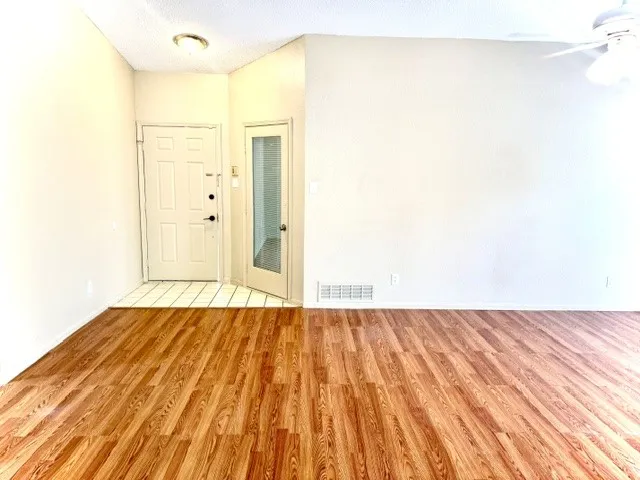 Wood-finish flooring throughout, complemented by light-toned wall finishes